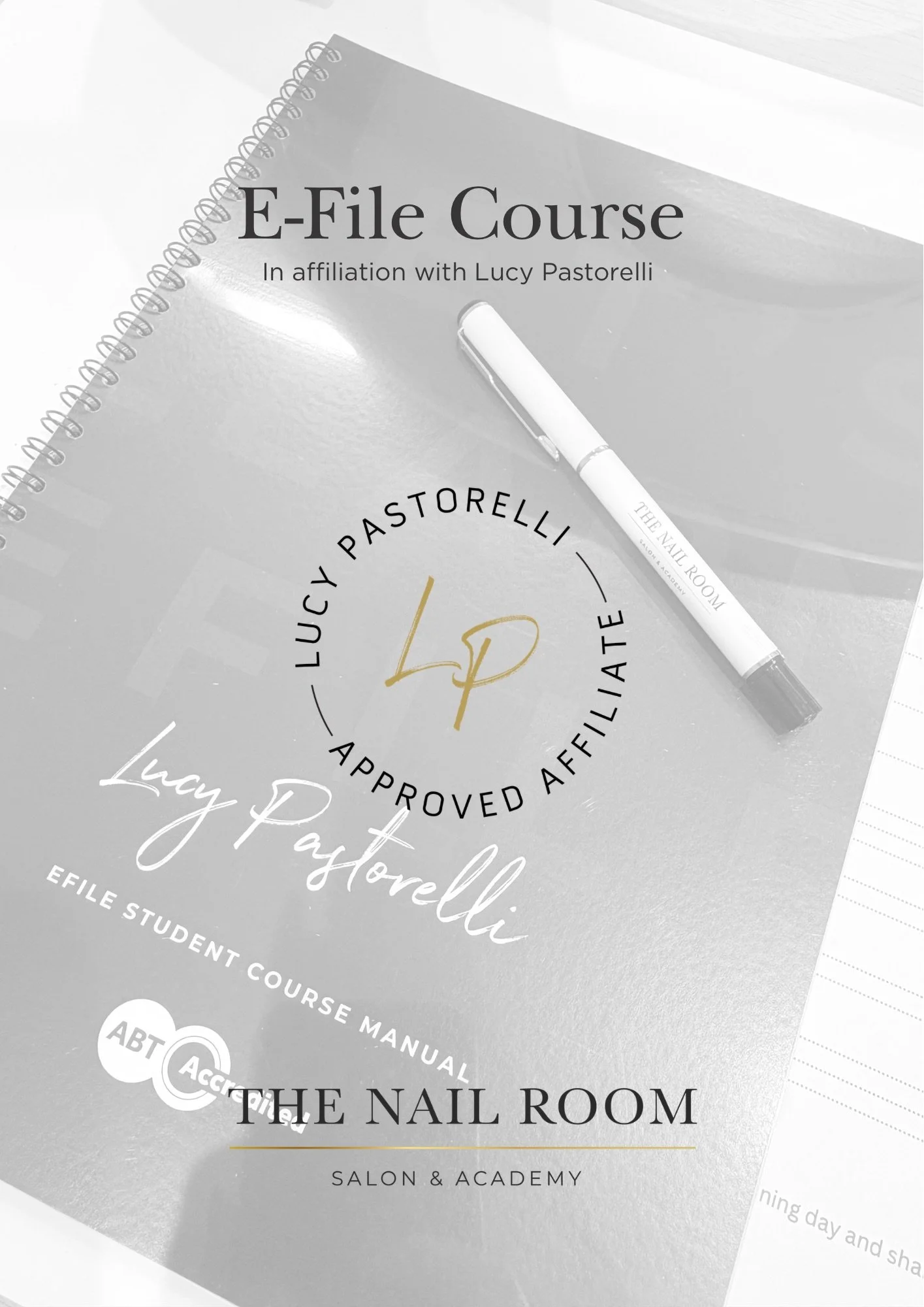 Cover page of a manual titled 'E-File Course' affiliated with Lucy Pastorelli, approved affiliate of Lucy Pastorelli, part of the EFile Student Course Manual at The Nail Room Salon & Academy, with a white pen resting on it.