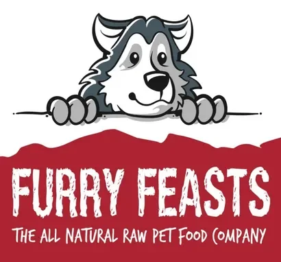 Cartoon husky peeking over a red banner that says "Furry Feasts" with smaller text below reading "The all natural raw pet food company".