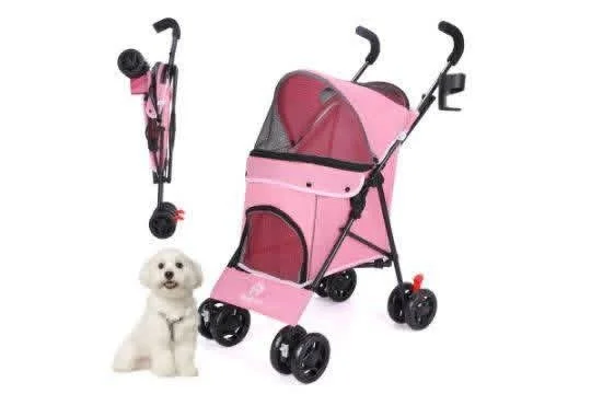 A pink pet stroller with a foldable design next to a small white dog and a folded pink travel bag.