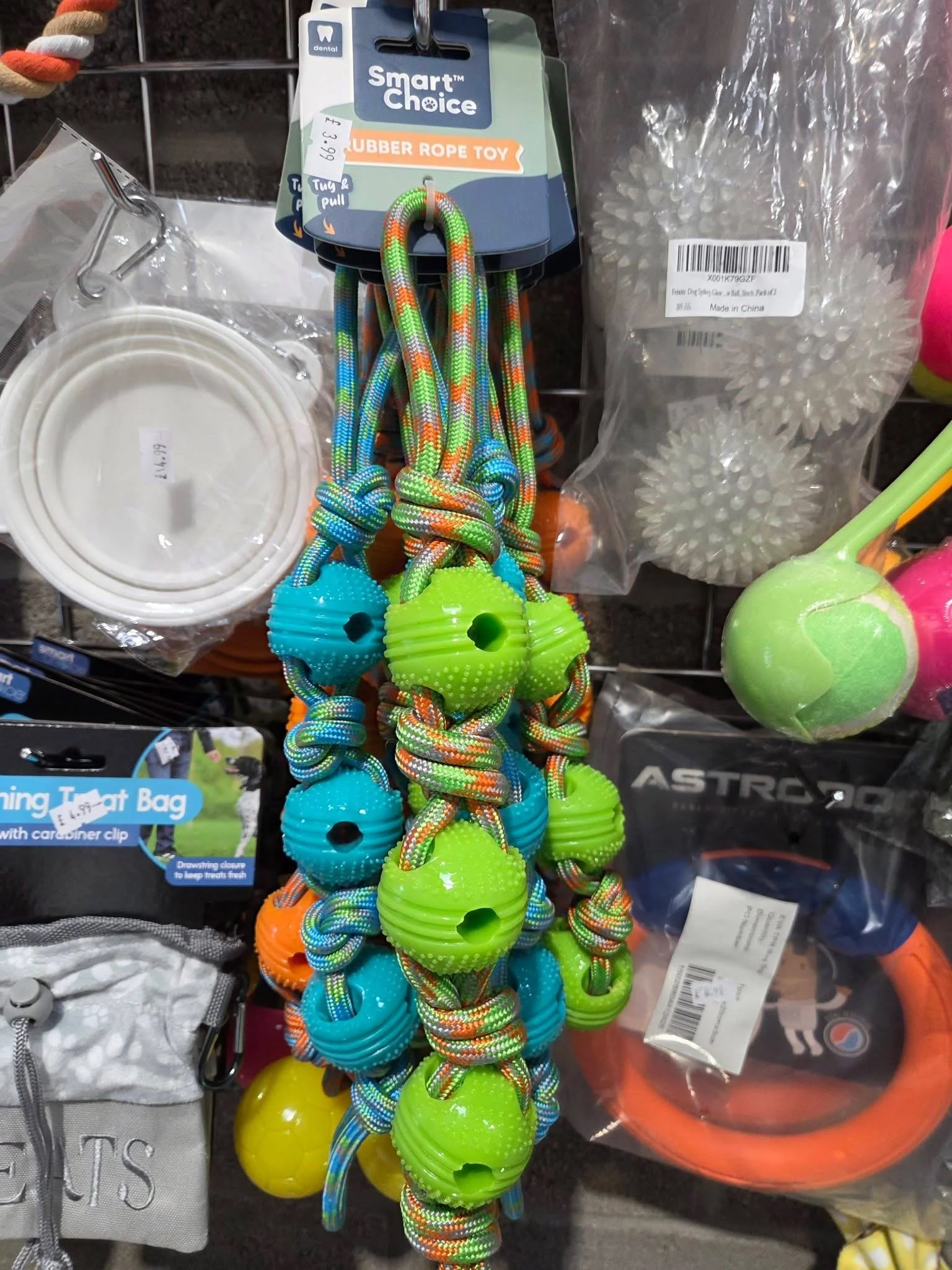 Colorful braided dog toys with green, blue, and orange rubber balls.