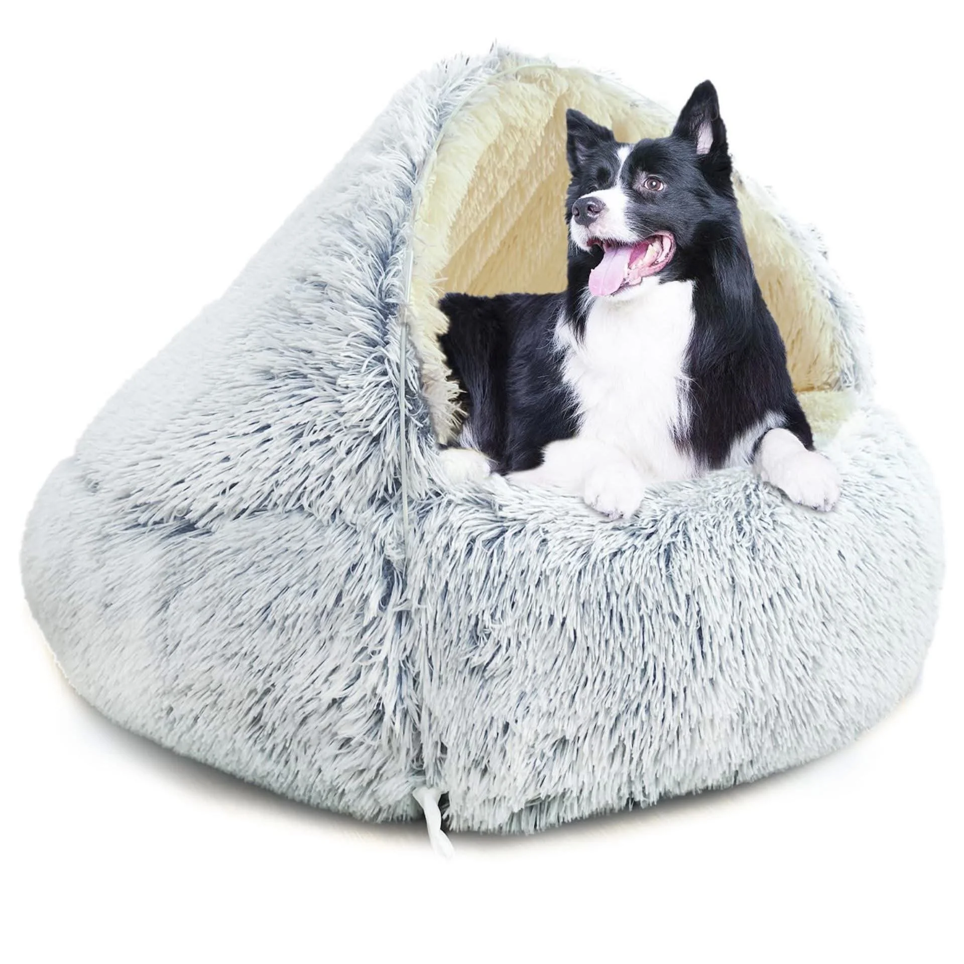 A black and white Border Collie dog lying inside a fluffy, round pet bed with a cream-colored interior.