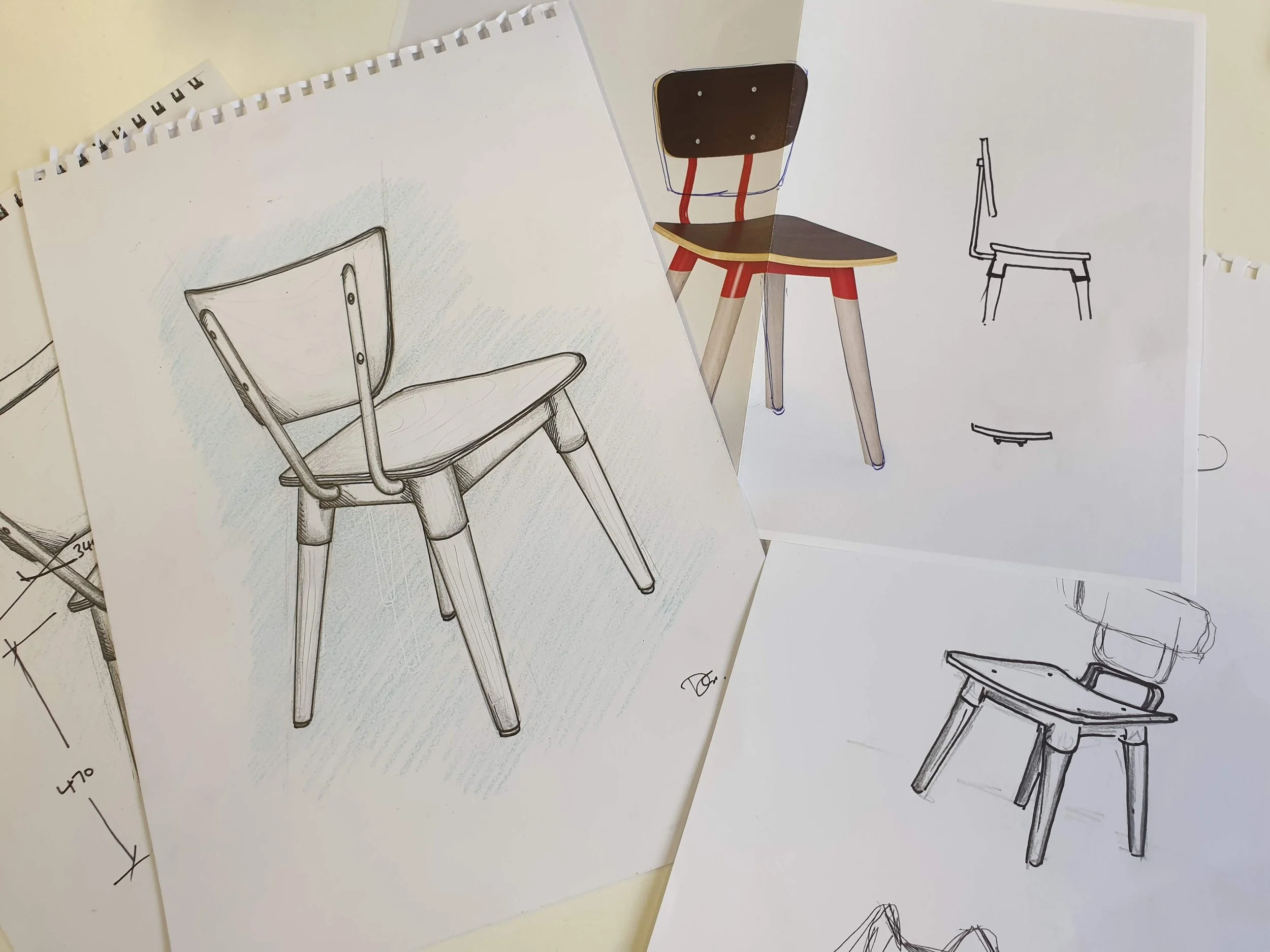 Sketches of a KFC chair in various styles, including a colored version with wooden seat and red and white legs, alongside pencil drawings.