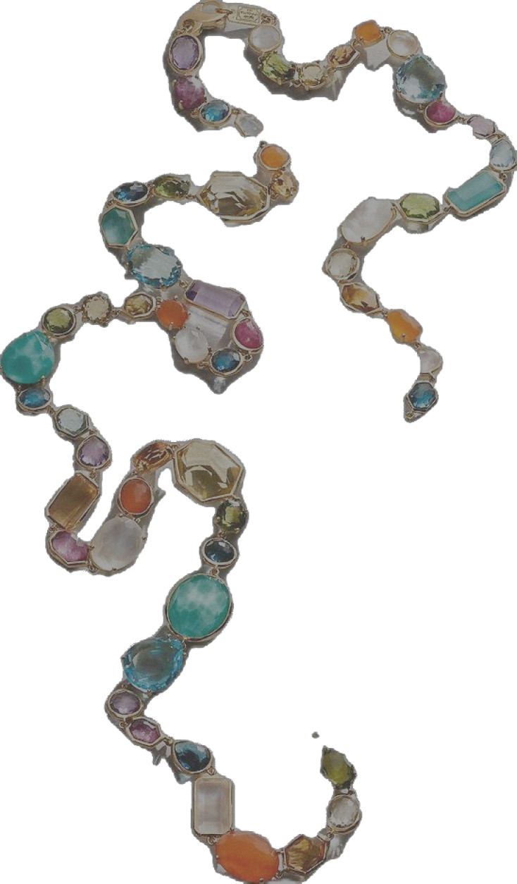 A pearl necklace arranged in the shape of a dollar sign ($) on a glass surface.