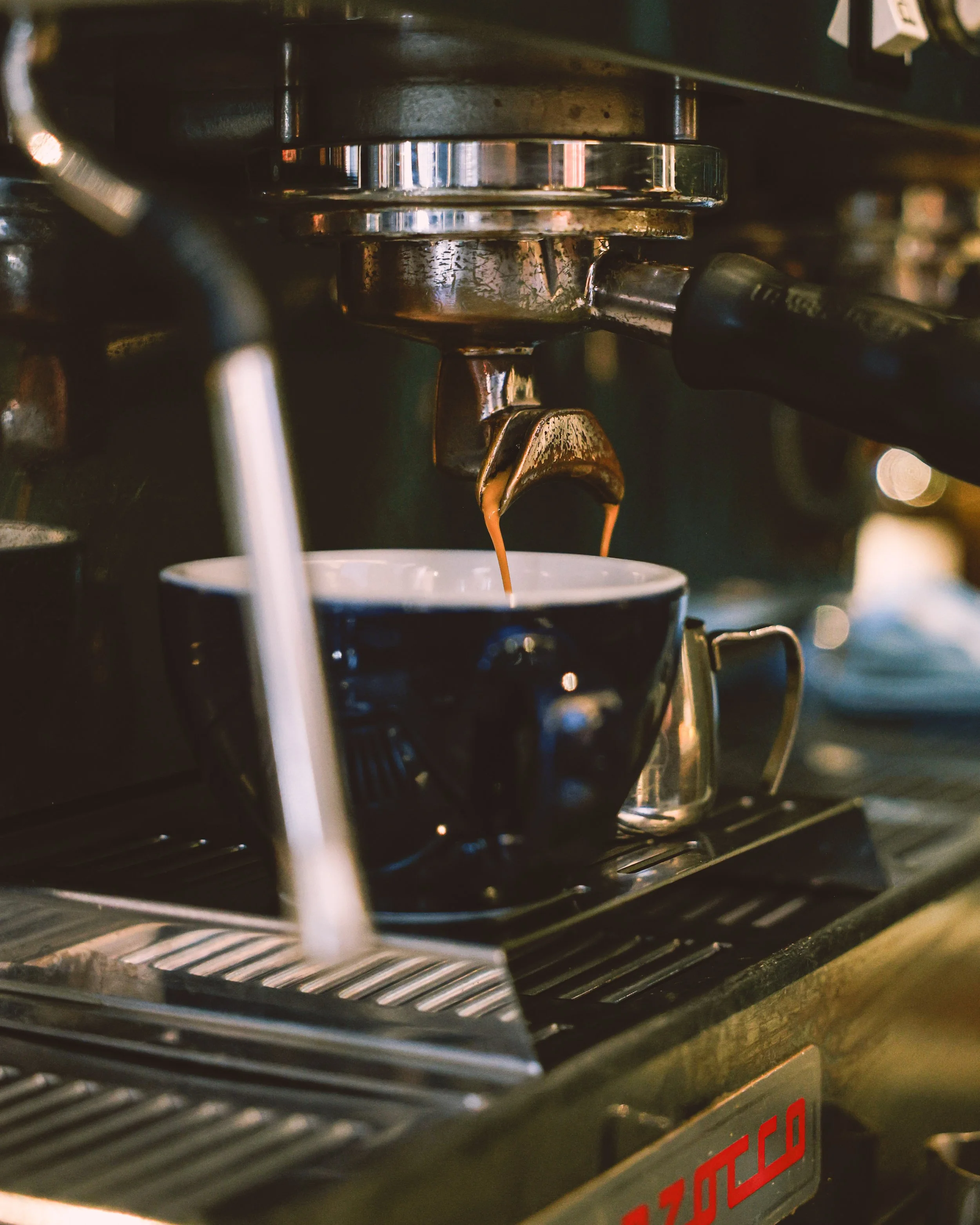 Espresso machine brewing coffee into a cup
