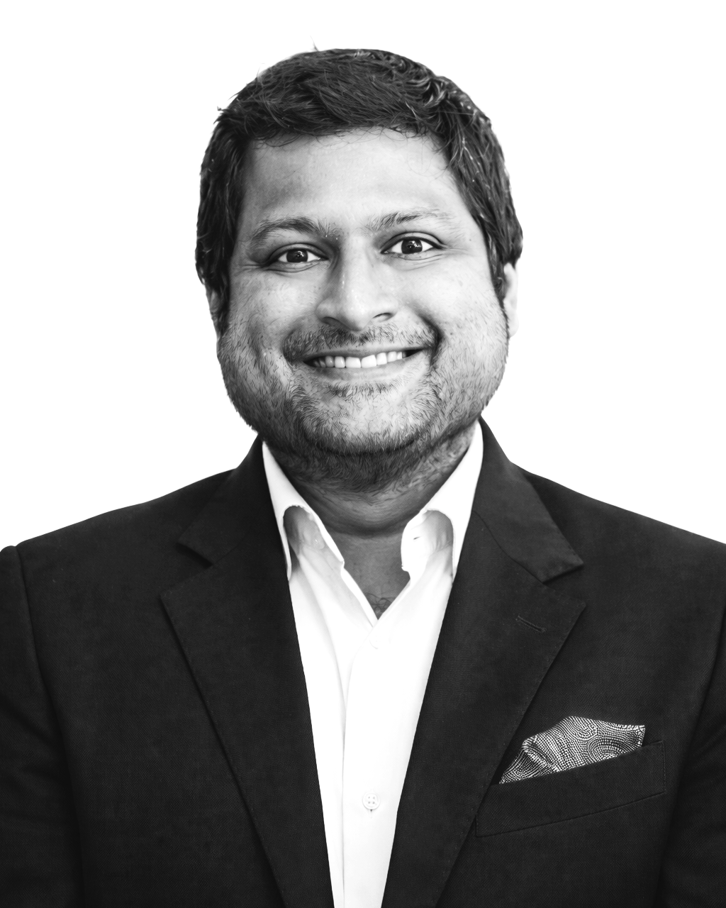 Black and white portrait of a smiling man wearing a dark suit jacket, white shirt, and patterned pocket square, against a plain white background.