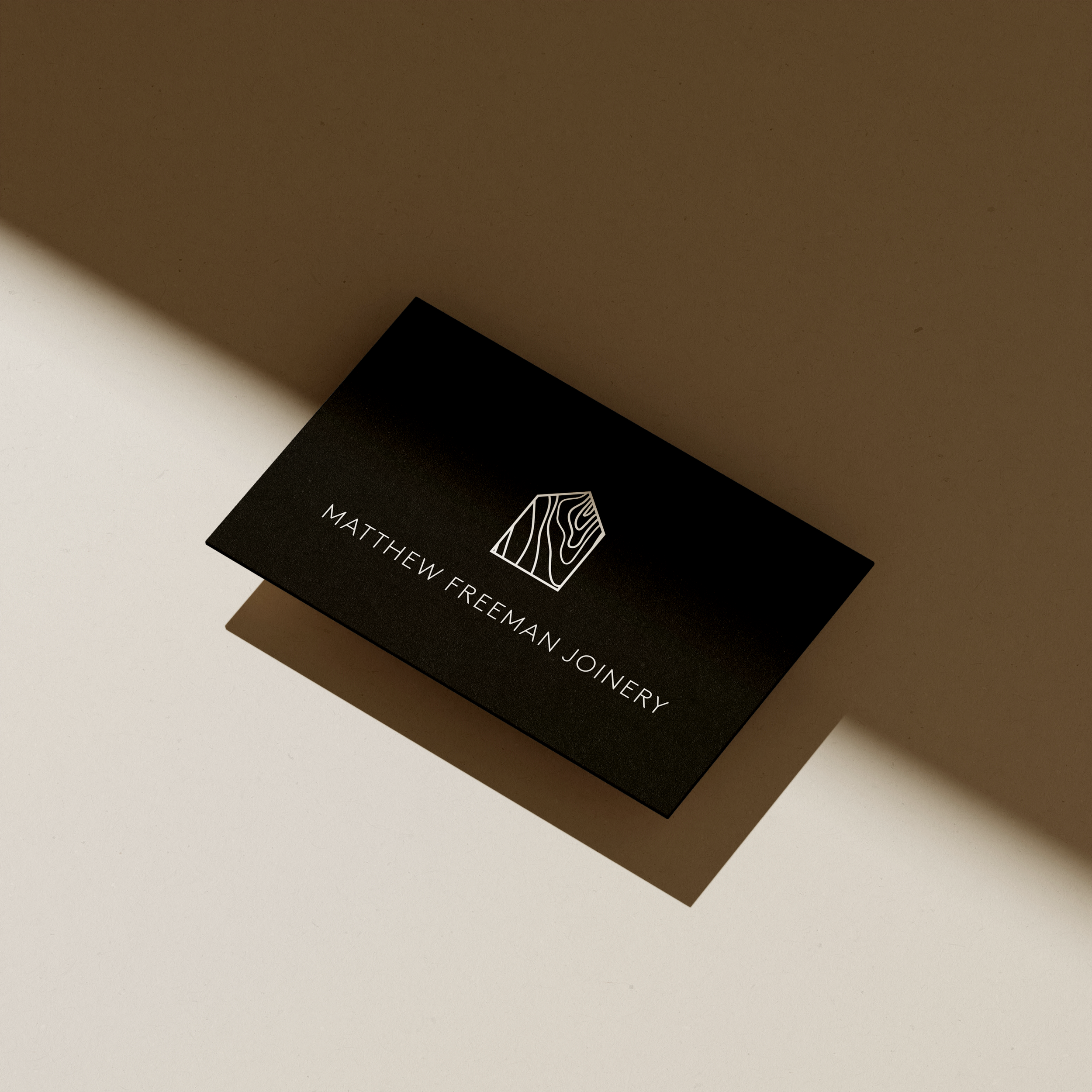 Business card design for a small business highlighting brand logo, colours, and contact information.