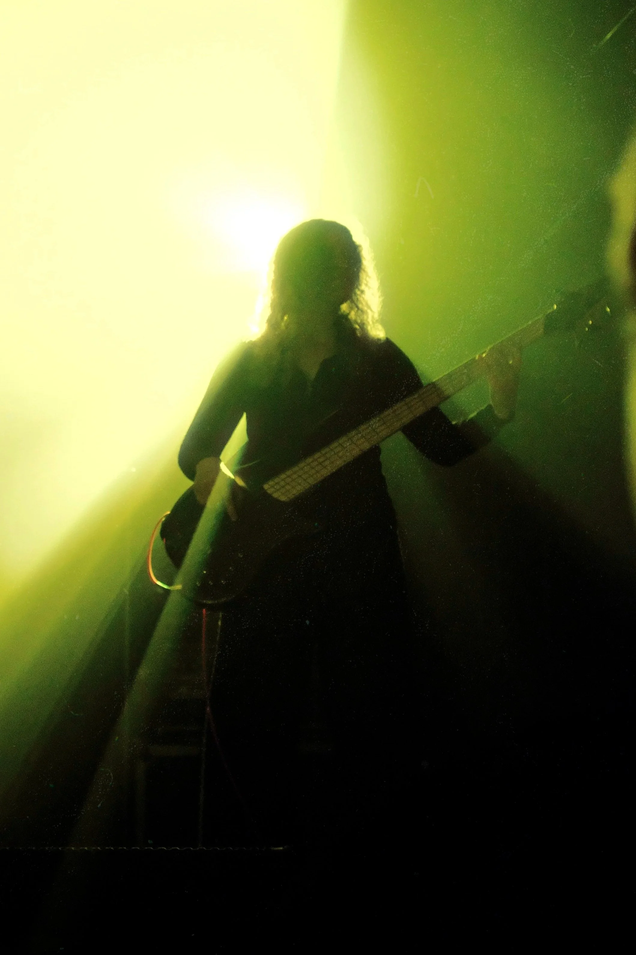 MILKYWAY bassist Monika live supporting Cog in Perth 2026 under green stage lighting