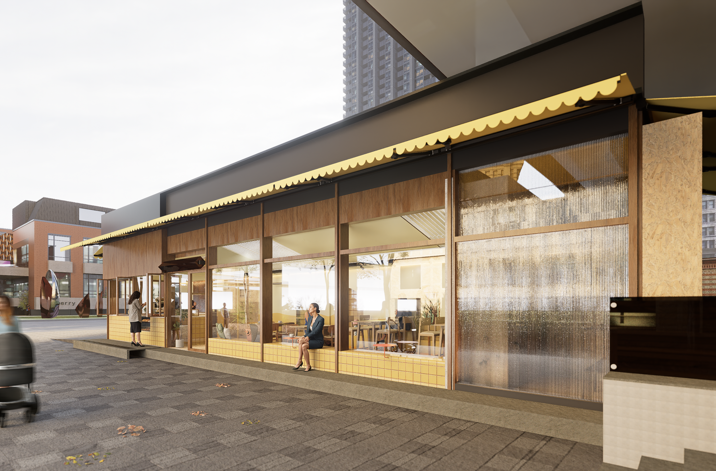 Een modern café met grote glazen ramen, houten en gele betegelde gevel, waar mensen inside zitten en buiten een vrouw op een bankje zit, in een stadscentrum met hoge gebouwen op de achtergrond.