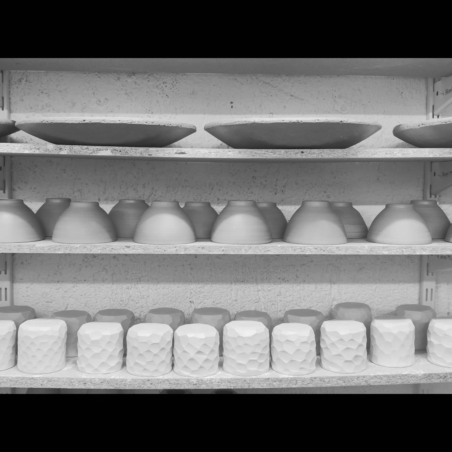 The shelves start filling again with pots. 
From the moment of throwing a piece on the wheel until it is ready, it is a long process. The pots first need to be trimmed after a day or two, then they need to dry slowly in a controlled environment, and 