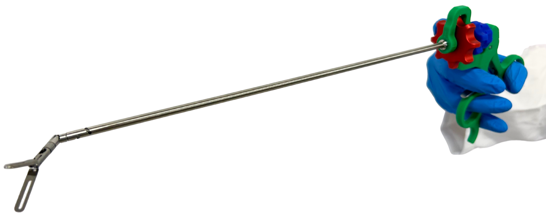 Articulating laparoscopic instrument by SATA Medical with a long metal shaft and a handle featuring two control wheels, held by someone wearing in a blue medical glove.