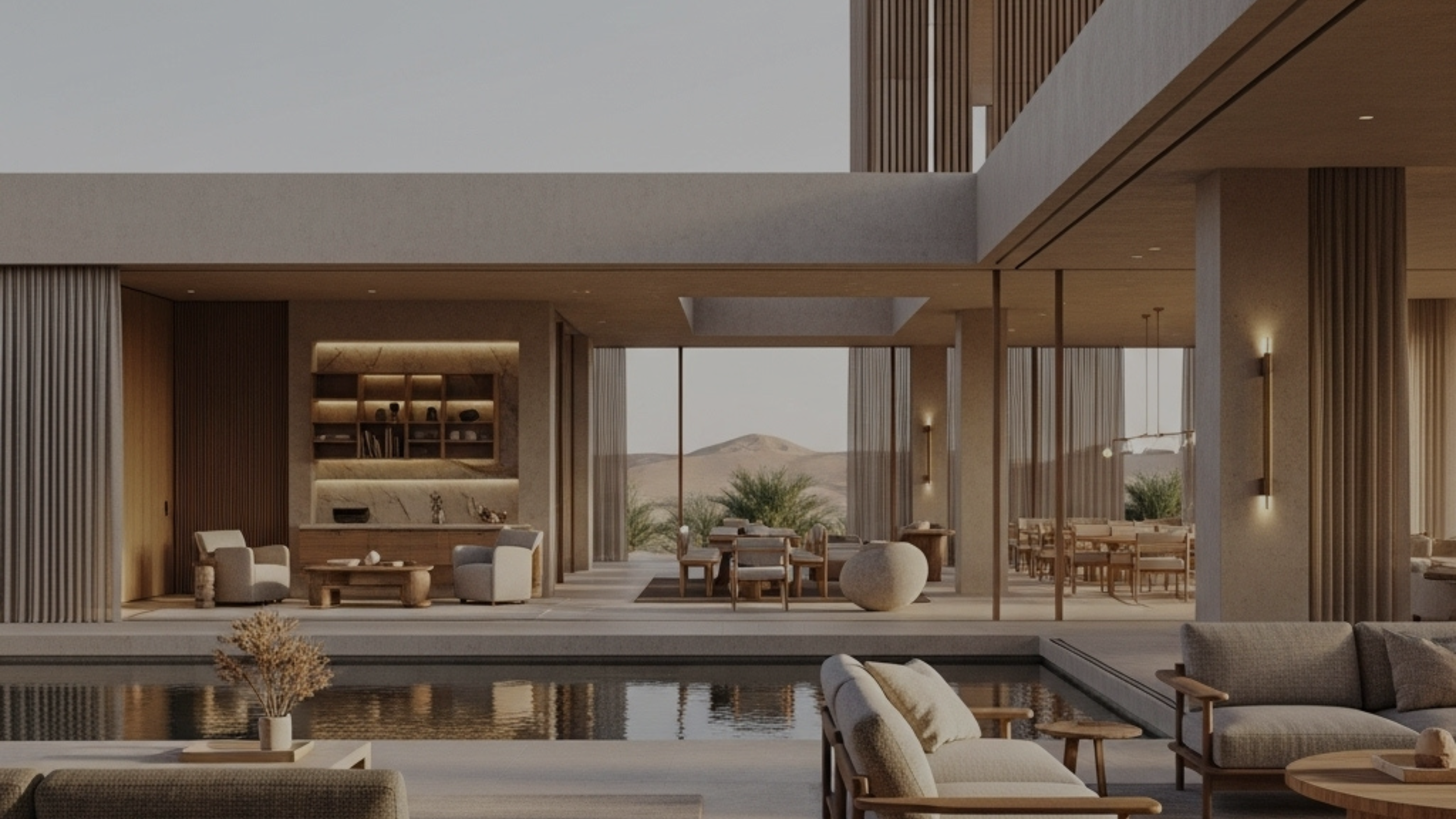 Modern open-concept living and dining room with neutral furniture, large glass windows, wooden accents, and a mountain landscape view