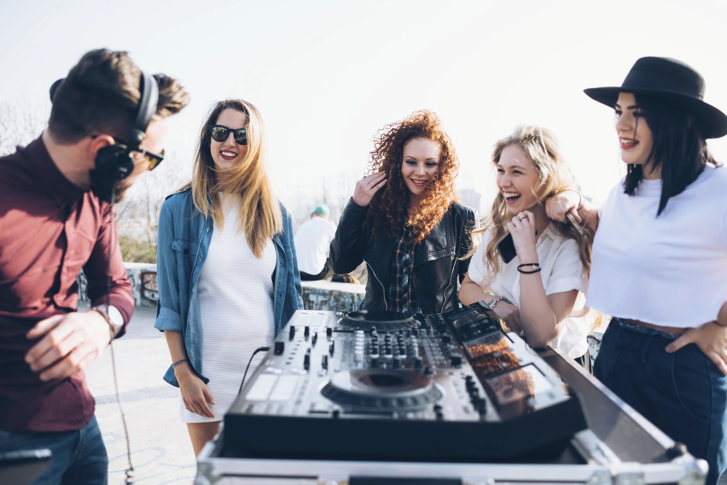 Friends participating in a group DJ activity in Las Vegas.