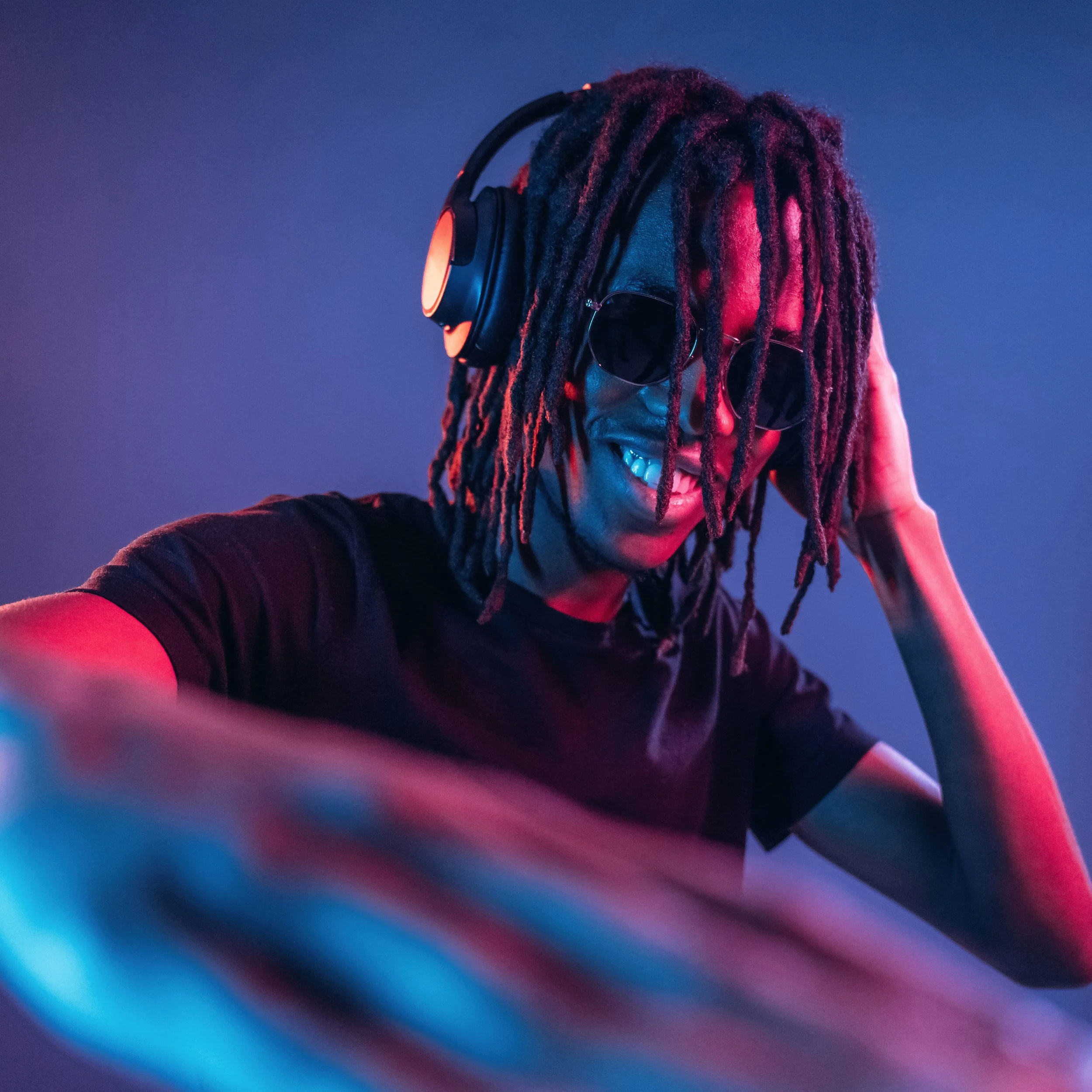 DJ mixing music under colorful lighting during a Las Vegas experience.