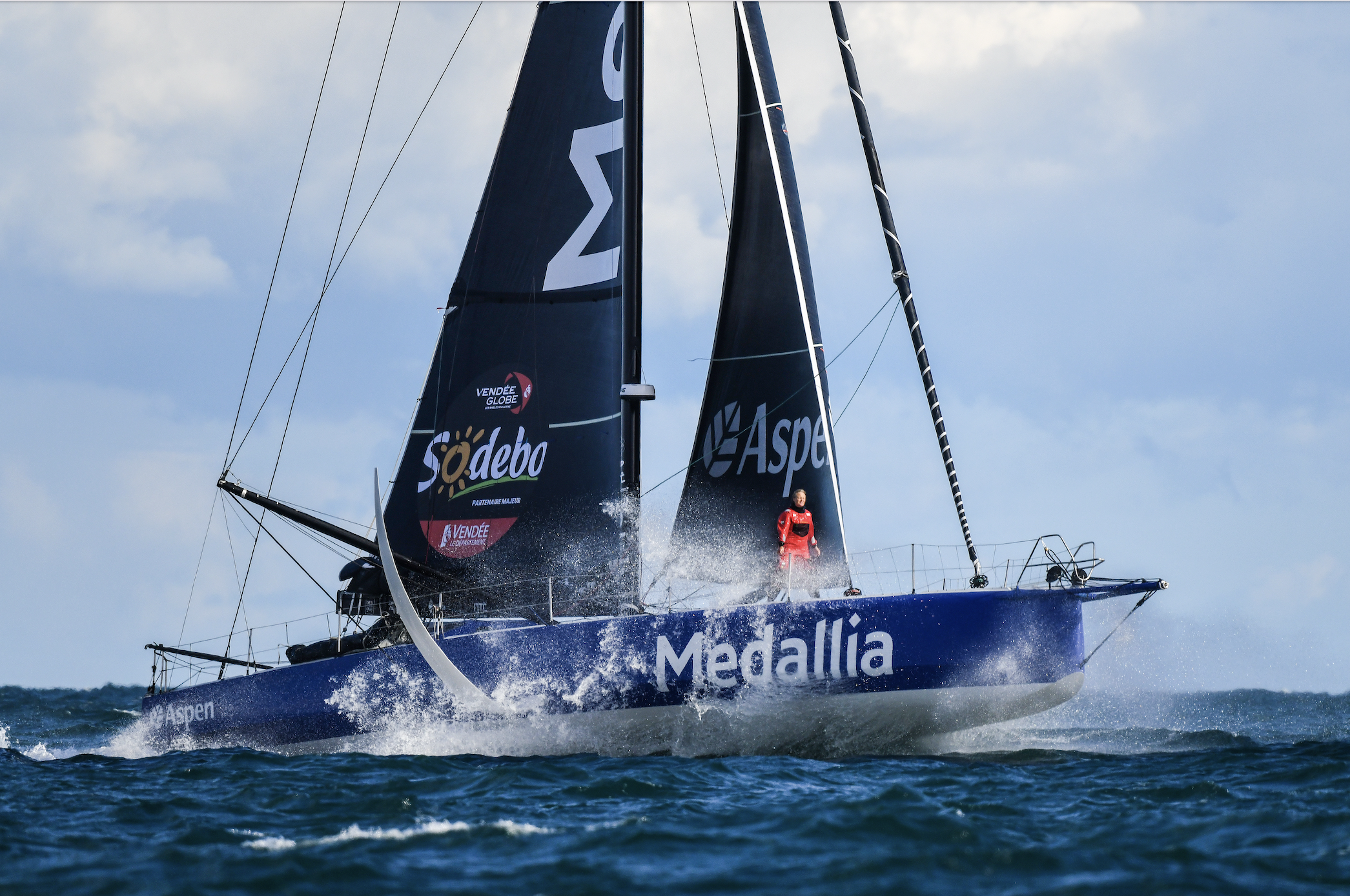 Pip Hare on bow of IMOCA 60 during Vendee Globe
