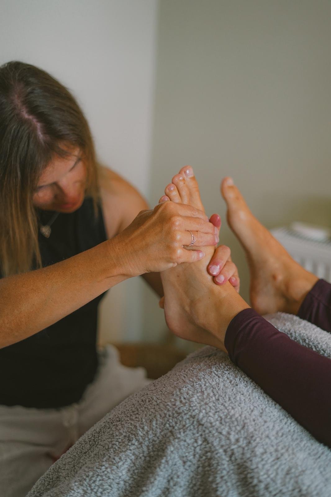 Stacy Lambert, a warm, deeply connective Reflexologist at The Alchemy Practice.