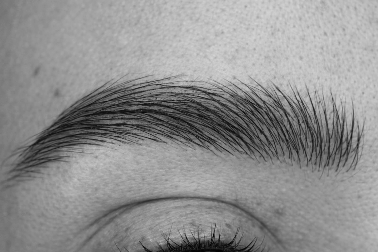 Close-up of female microbladed brows with natural hair stroke technique at Sanct Noir Studio Leeds