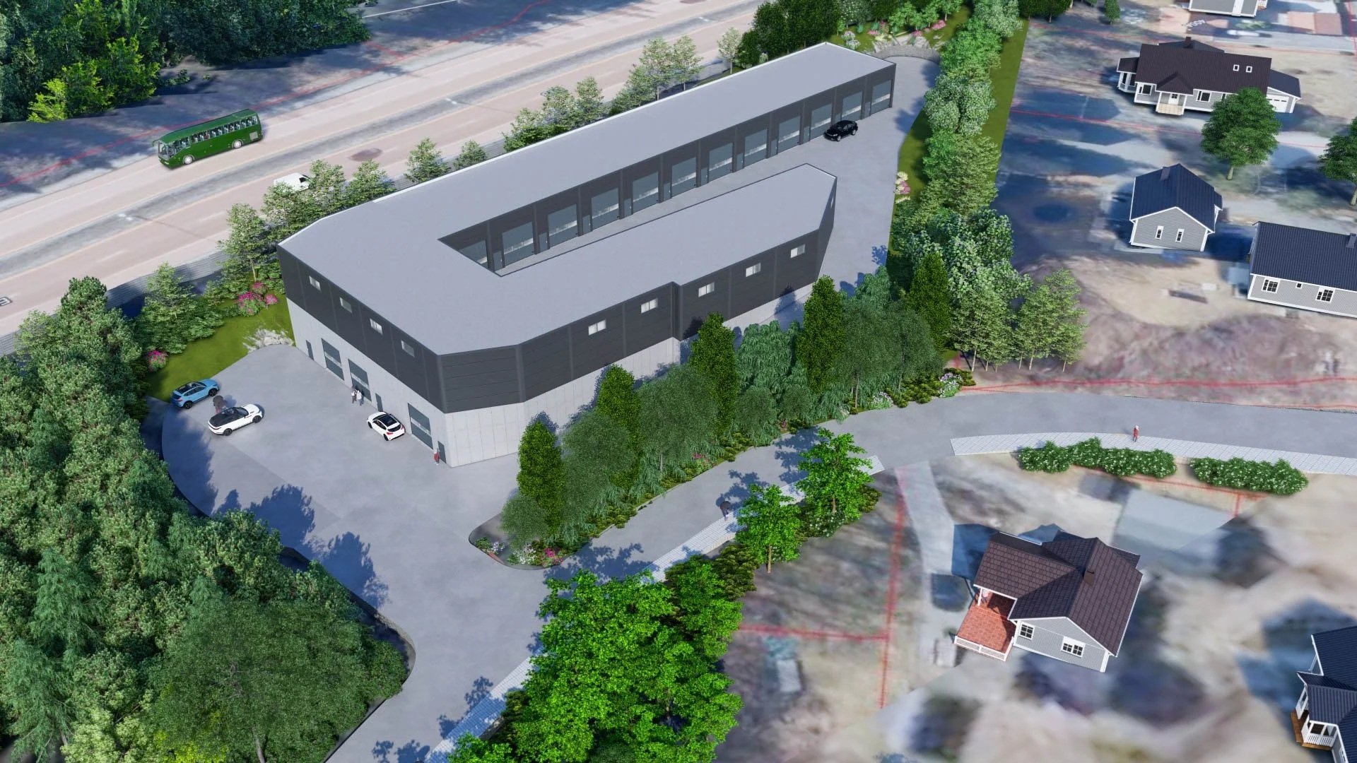 Aerial view of a modern commercial building with a curved shape, surrounded by parking lot, trees, and adjacent residential houses in the background.