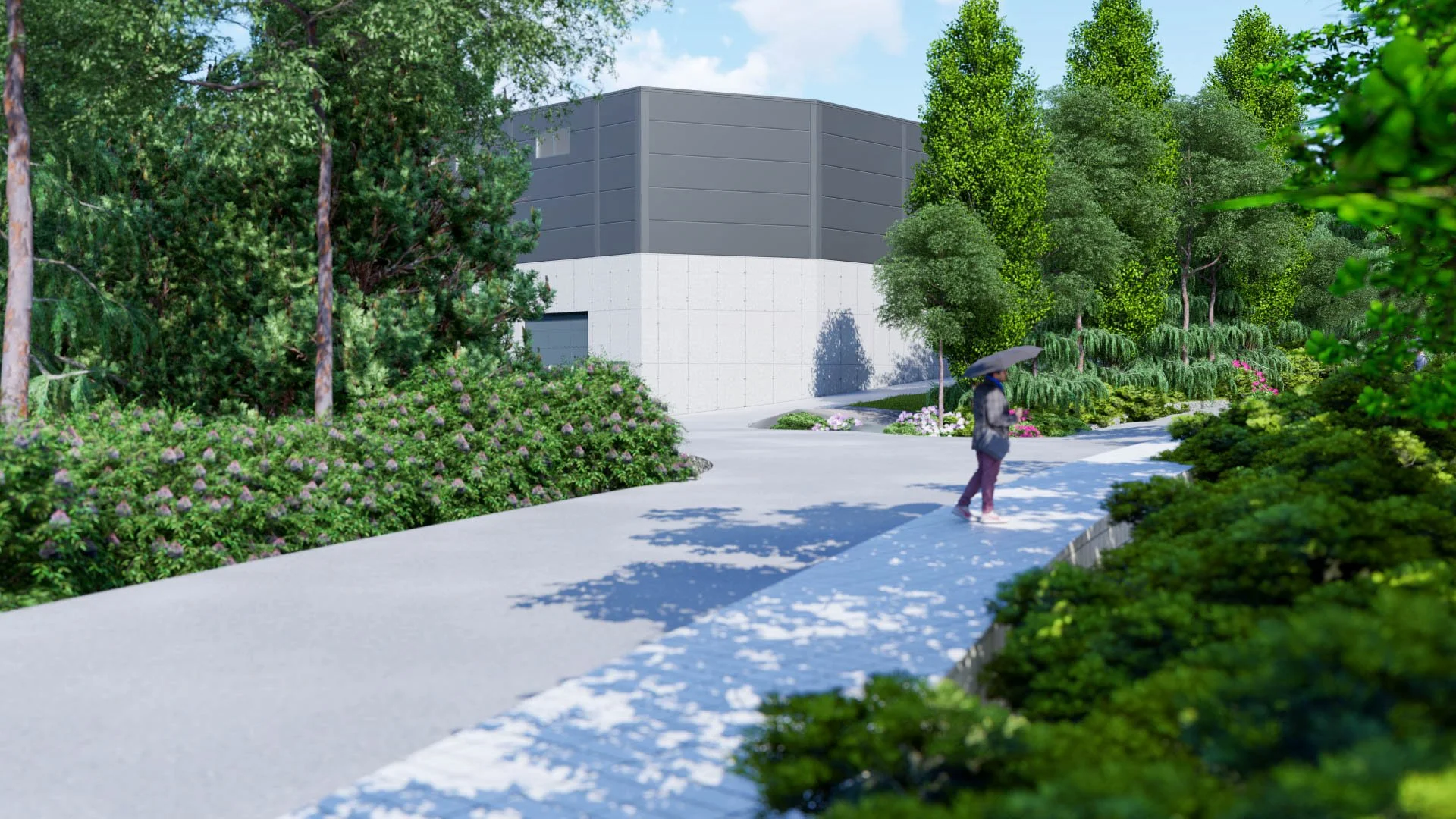 A person walking with an umbrella on a sidewalk surrounded by lush green trees and bushes near a modern building.