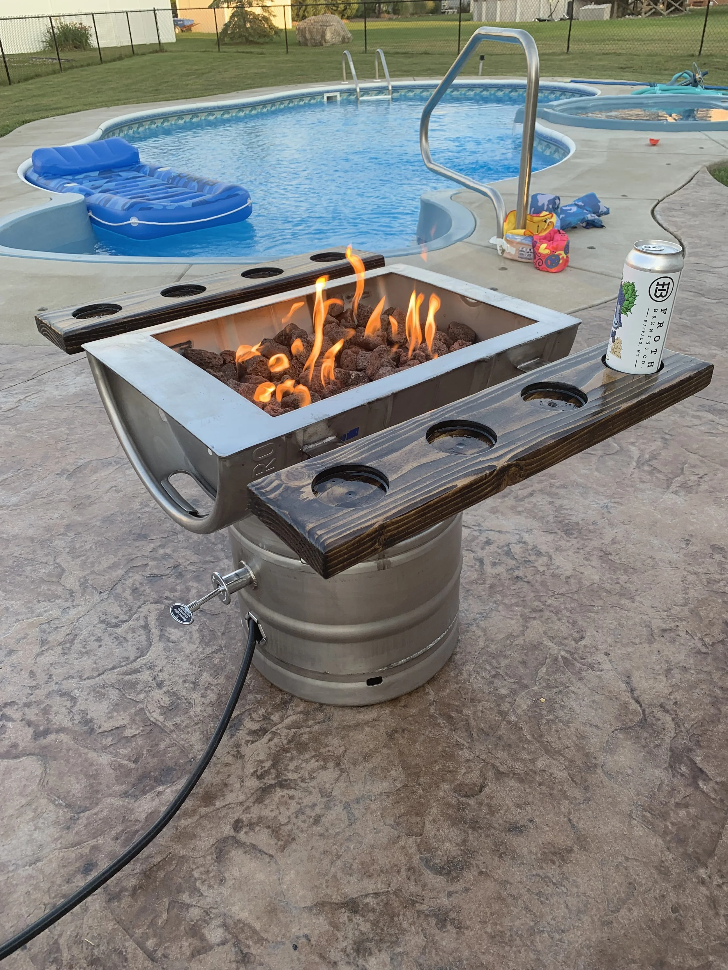Custom Keg Fire Table.  Full Keg holding up a Keg cut in half creating the fire feature along with side shelves for your drinks or marshmallows.  