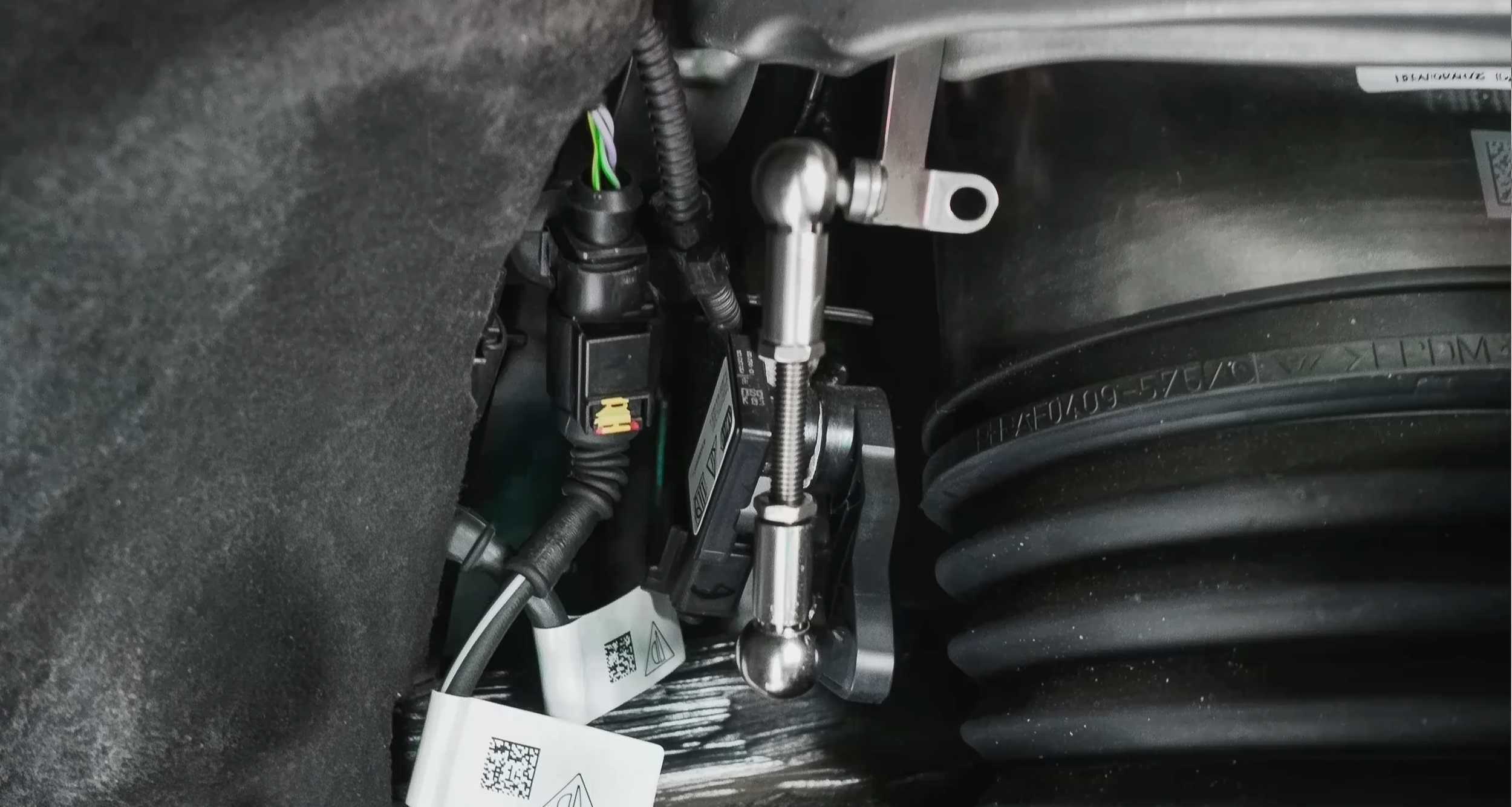 Lowering link installed on air suspension ride height sensor showing real vehicle integration