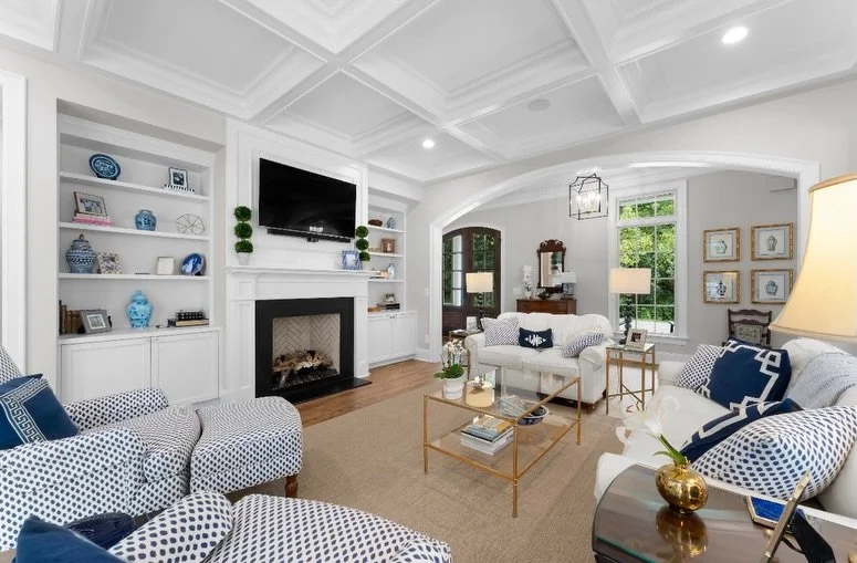 From the moment you walk in, you can feel the intention behind every detail we built into this space. The coffered ceilings and custom built-ins framing the fireplace create a living room designed for slow mornings, family gatherings, and everything 