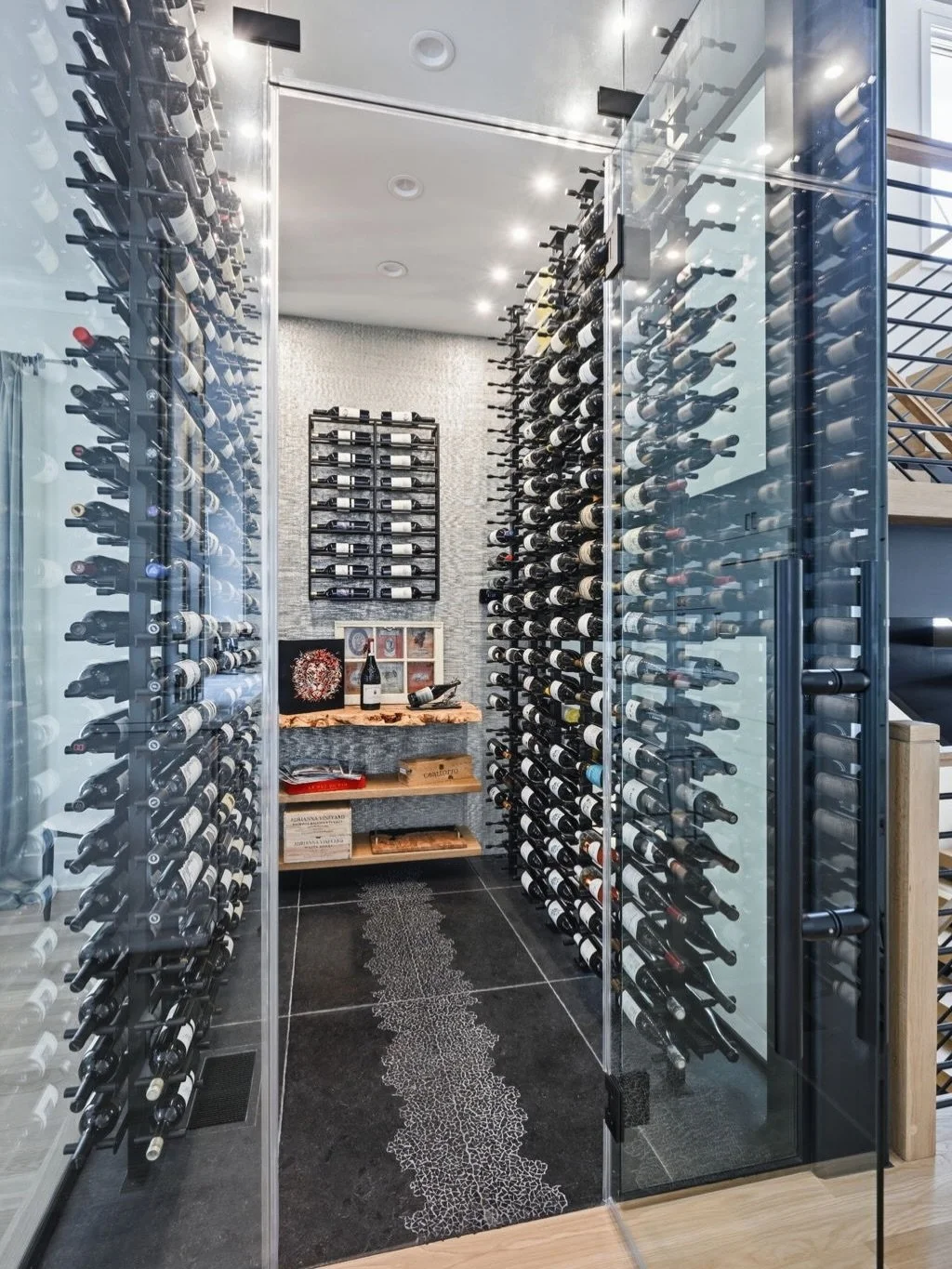If you know these clients, you know there&rsquo;s always a reason to get together. 

Their custom wine room is the perfect fit for a couple who love entertaining and whose home is often the gathering spot for friends and neighbors. With glass walls, 