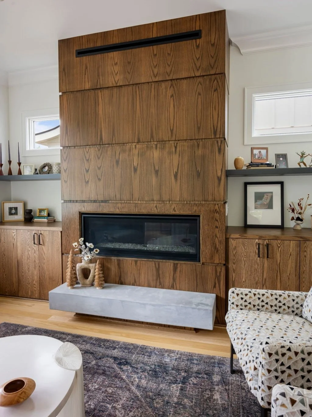 We loved building this home, and it&rsquo;s always so special to see a house come together with the homeowners&rsquo; own style and personality. This living room has so many things to love, from the beautiful custom wood fireplace  to the artwork, pa