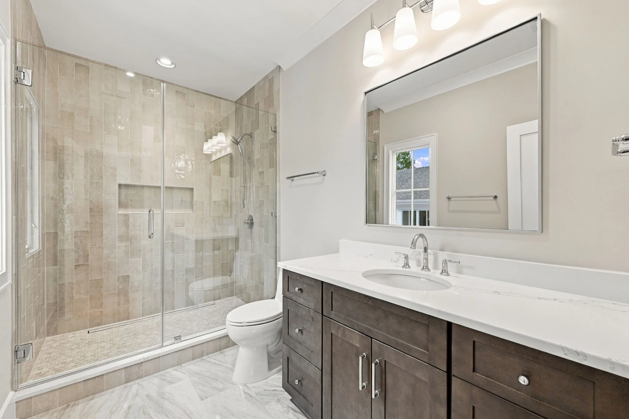 Yesterday, we shared a look at the main living spaces of this newly finished custom home. Today, we&rsquo;re taking you into the five bathrooms, each with its own details, finishes, and personality.

From the tile and countertops to the fixtures and 