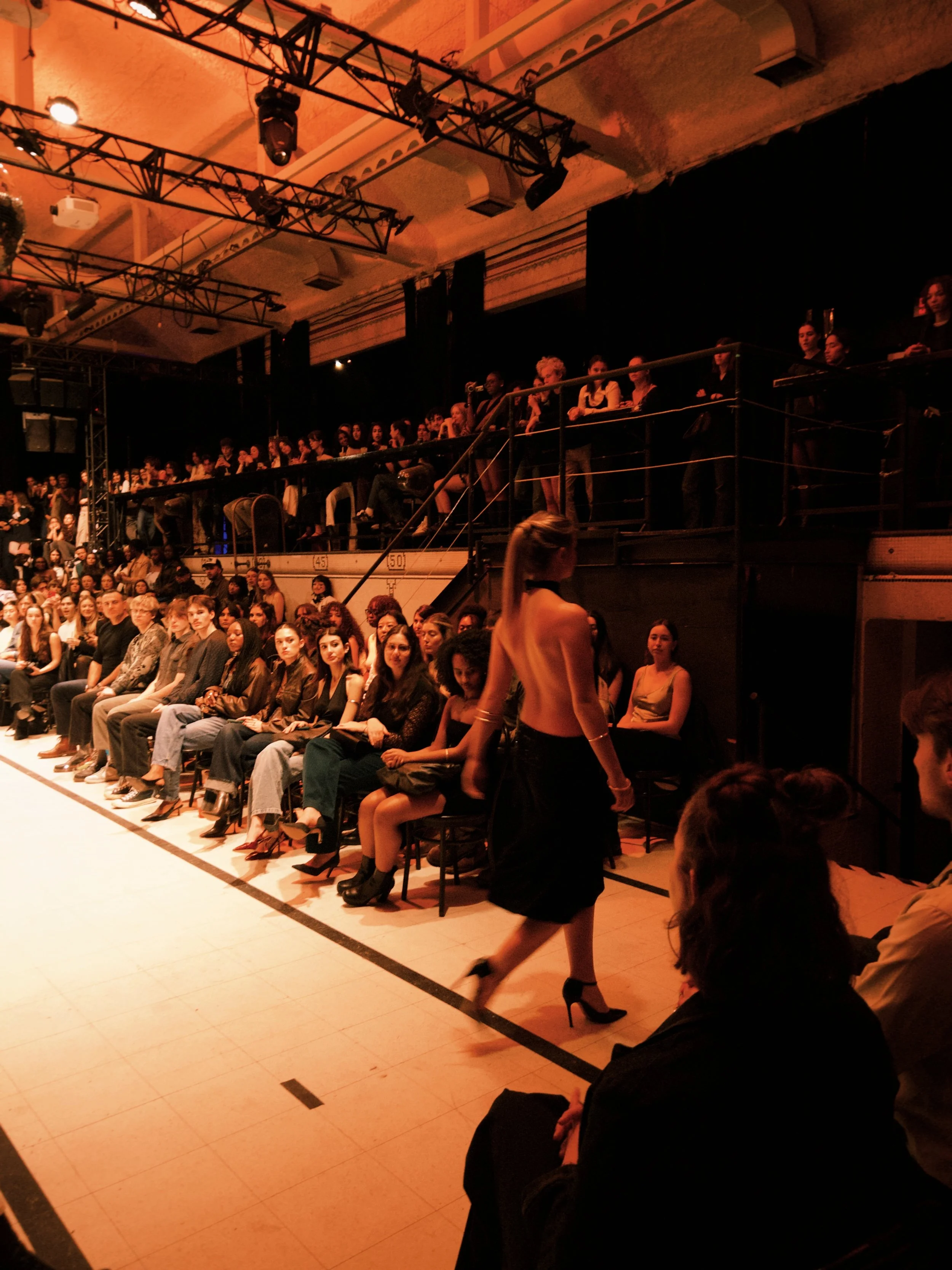 Georgia, wearing a black dress made from recycled and second-hand fabrics