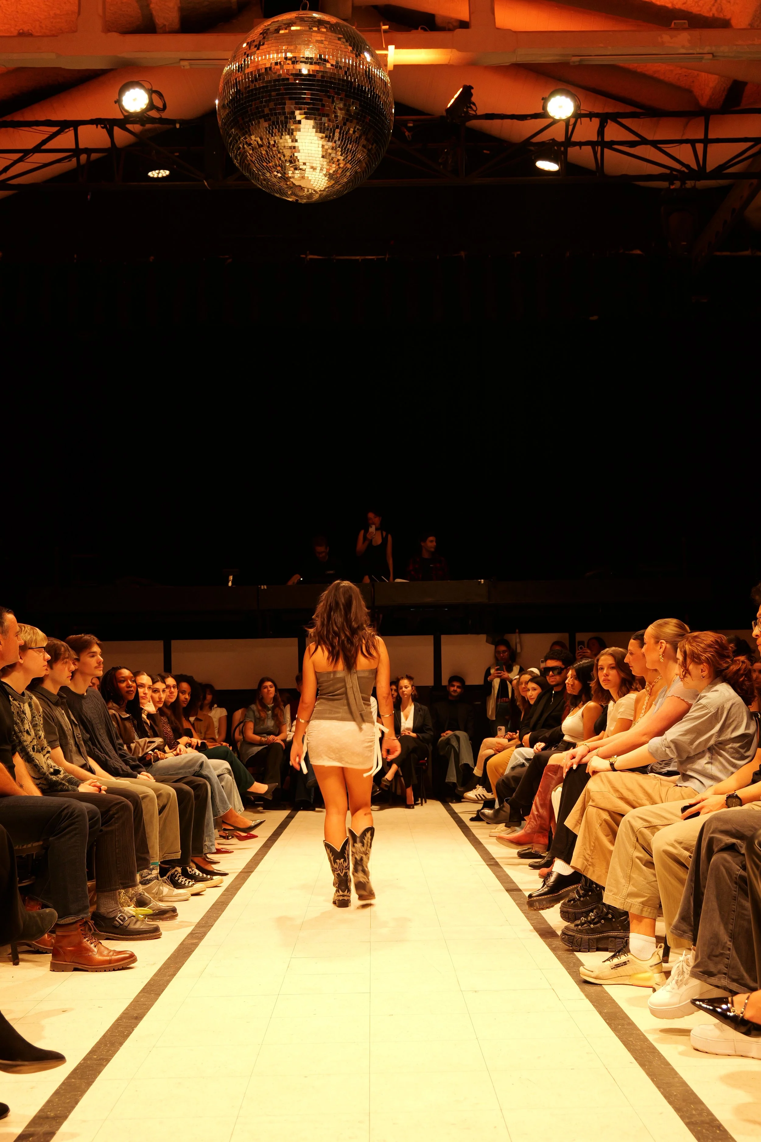 Angelina, wearing a lace skirt and bandeau top made from recycled and second-hand fabrics