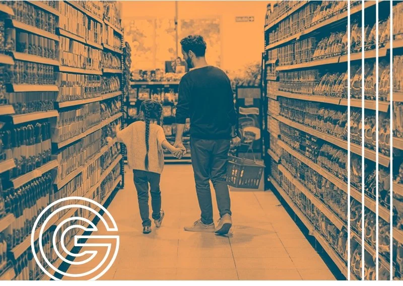 A father and daughter in the aisle of a grocery store