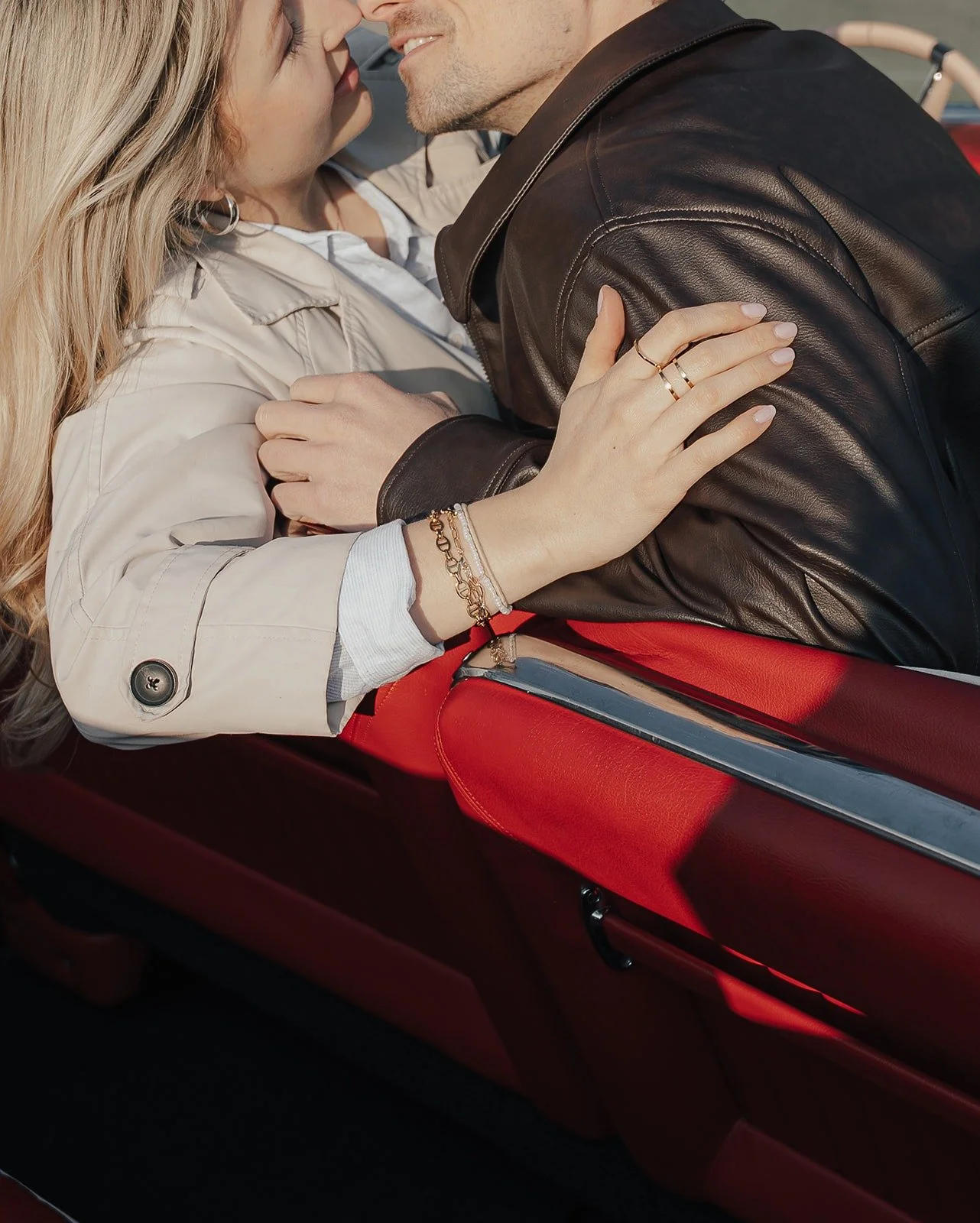 Couple kissing on red leather seats in a vintage Cadillac – Old Hollywood editorial by Anna van der Veen