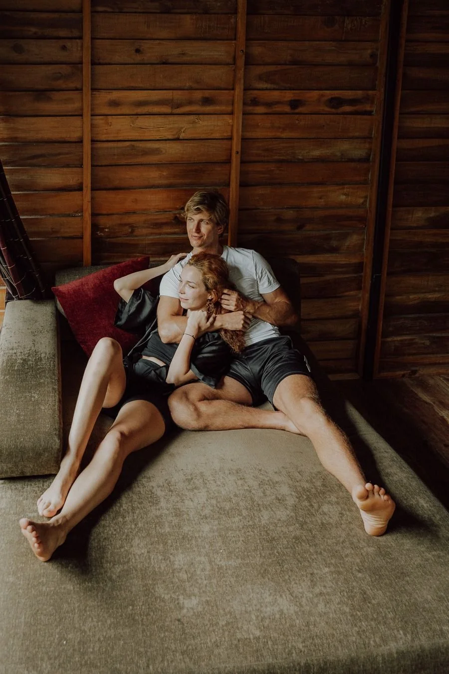 Anna and Niklas relaxing together on a daybed inside a wooden treehouse at The Glenrock, Sri Lanka