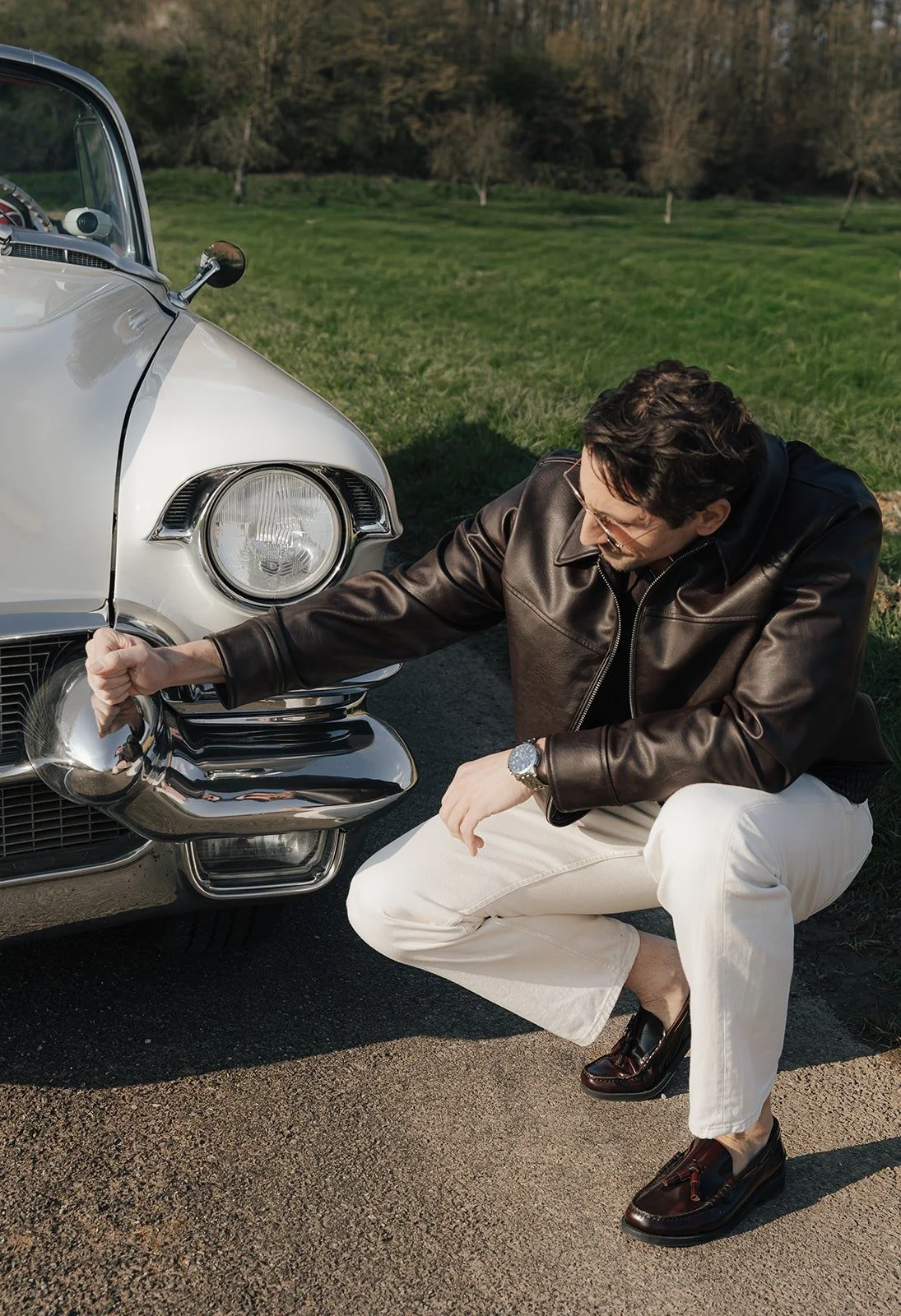 Man leaning on the chrome of a white vintage Cadillac – Old Hollywood editorial by Anna van der Veen