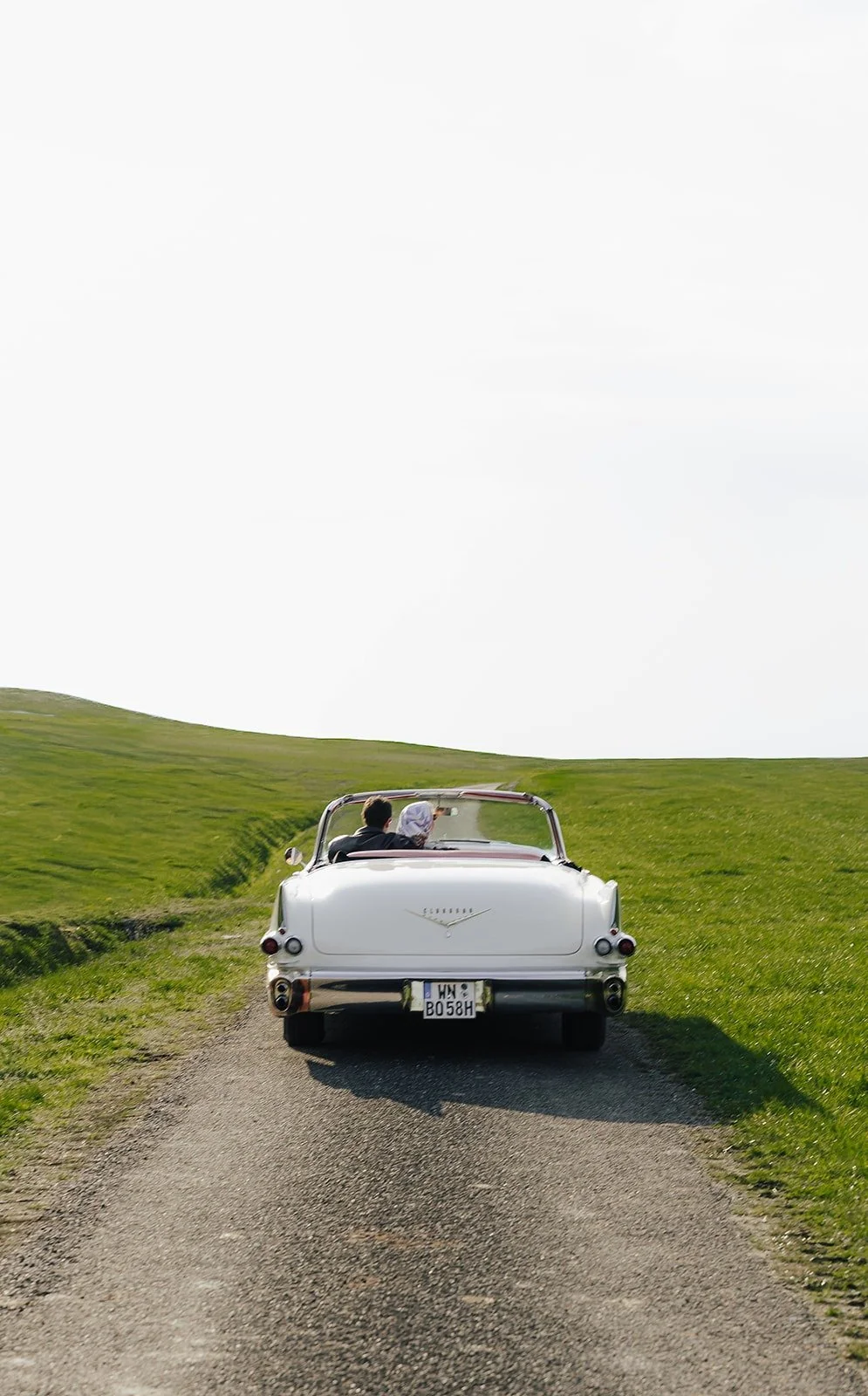 White vintage Cadillac driving down a country road – Old Hollywood editorial by Anna van der Veen