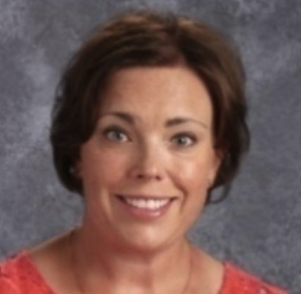 Headshot of a woman with short brown hair, smiling, wearing a red top, against a gray background.