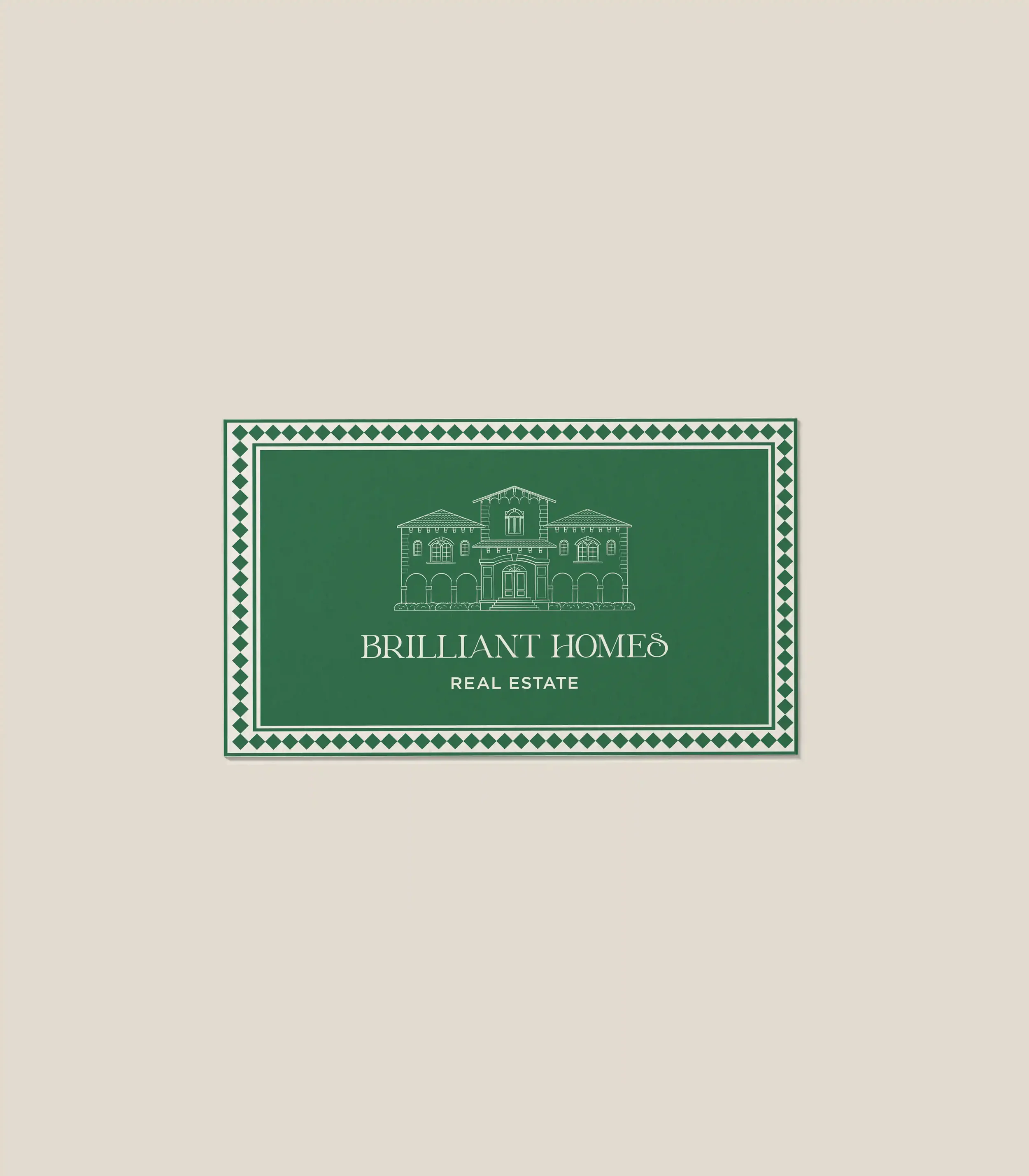 Logotipo de una compañía de bienes raíces llamada 'Brilliant Homes' con una ilustración de una casa en verde y blanco.