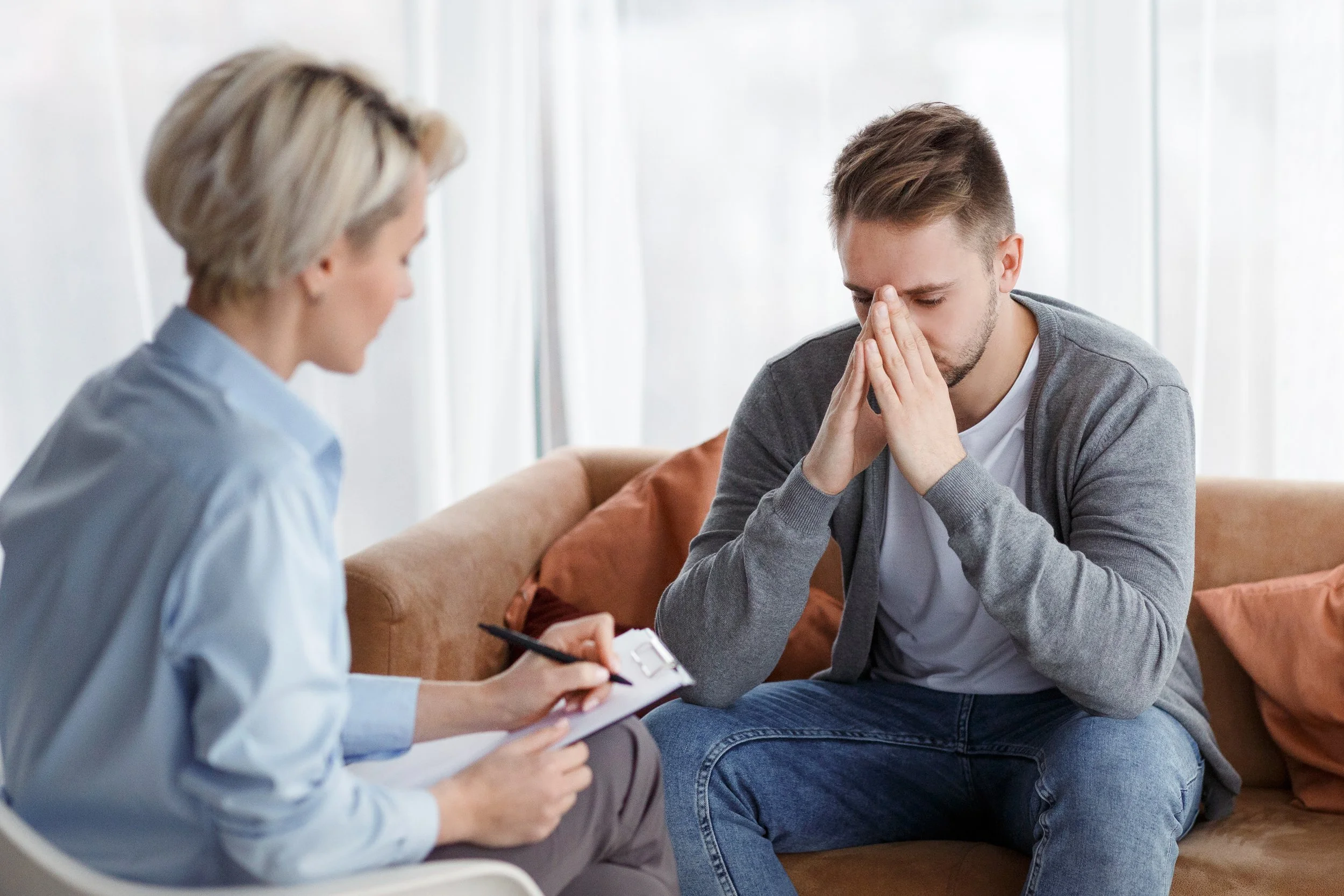 Depression Counseling. Man talks to a councelor after sustaining loss.