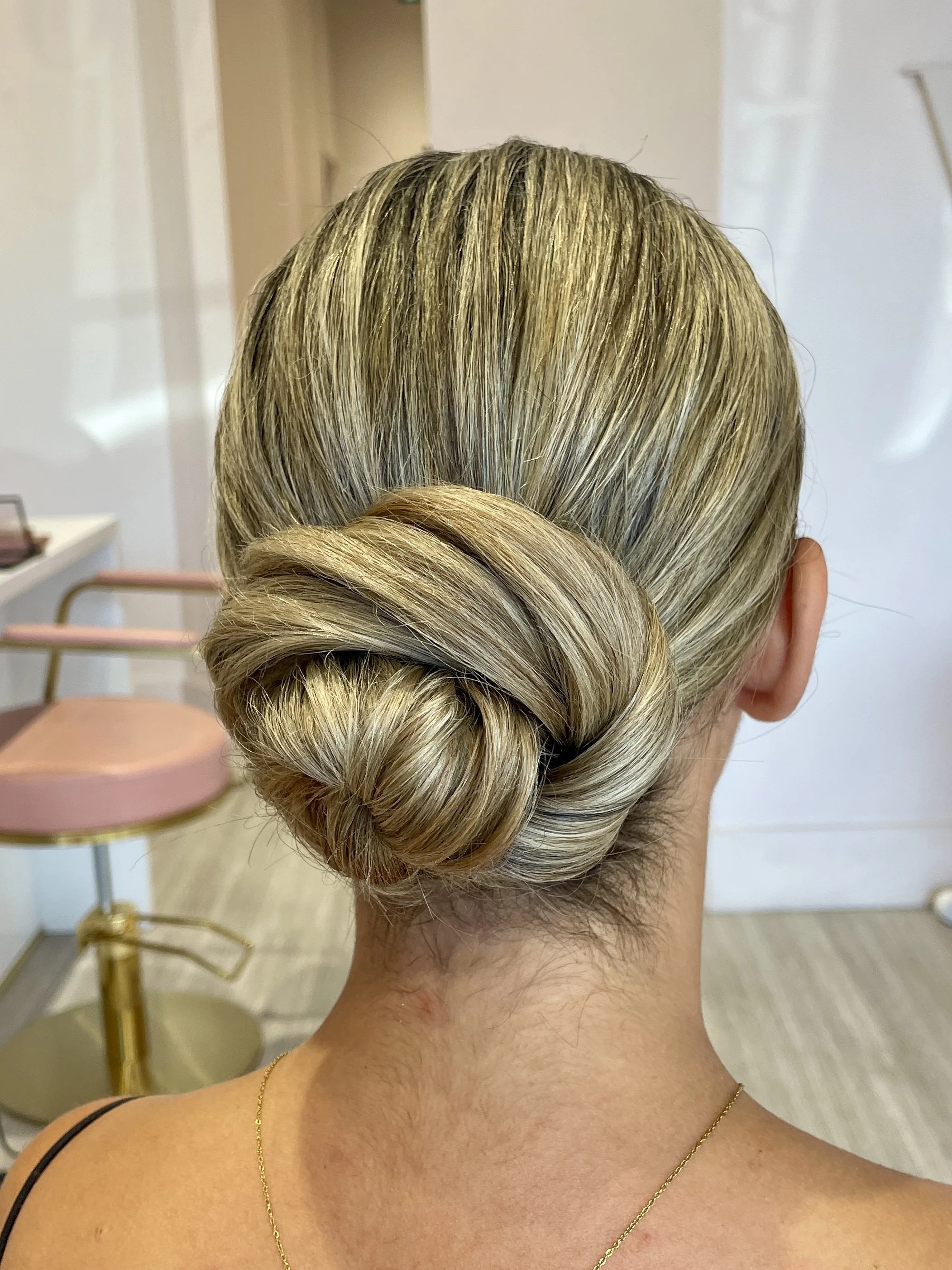 Back of woman's head with a neatly styled low bun.