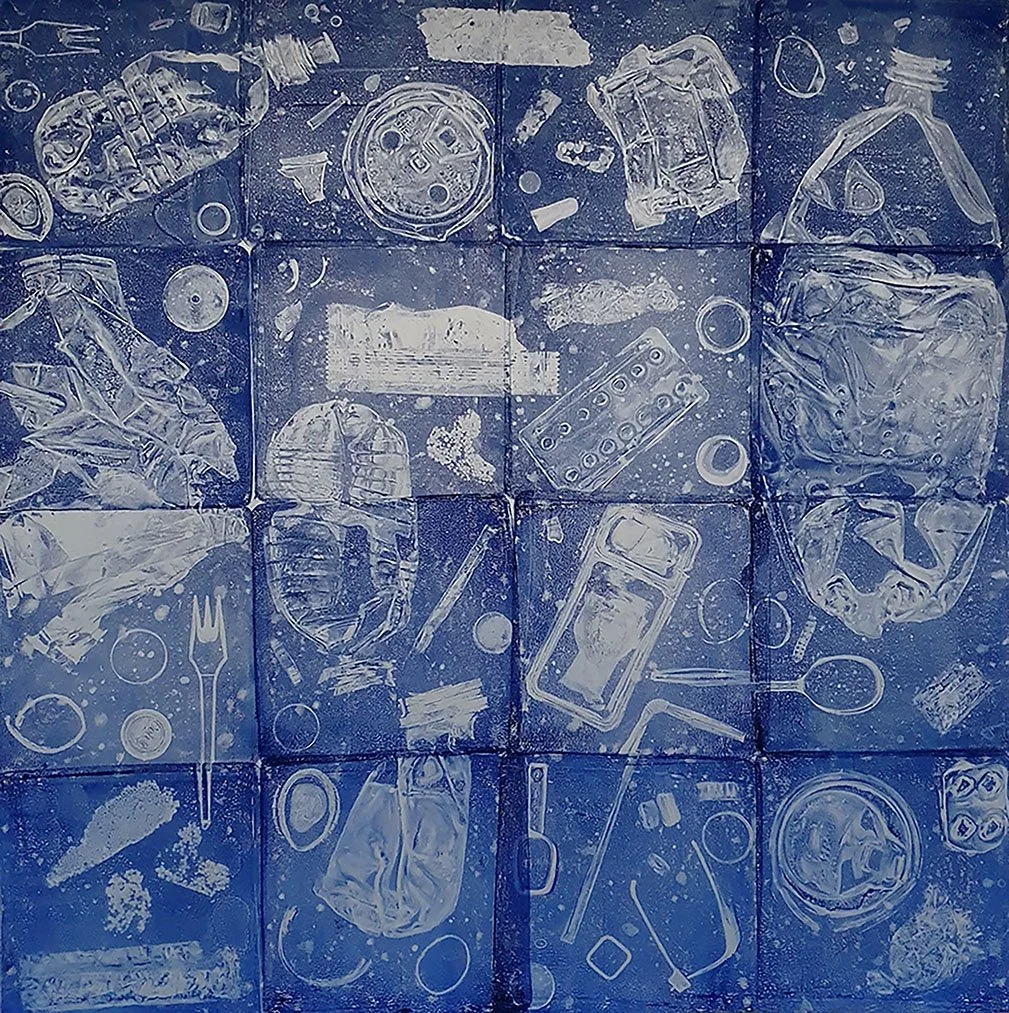 A mural painted with white spray paint on blue tiles depicting various trash items like plastic bottles, cans, a fork, a spoon, a vacuum cleaner, and other debris, illustrating pollution.