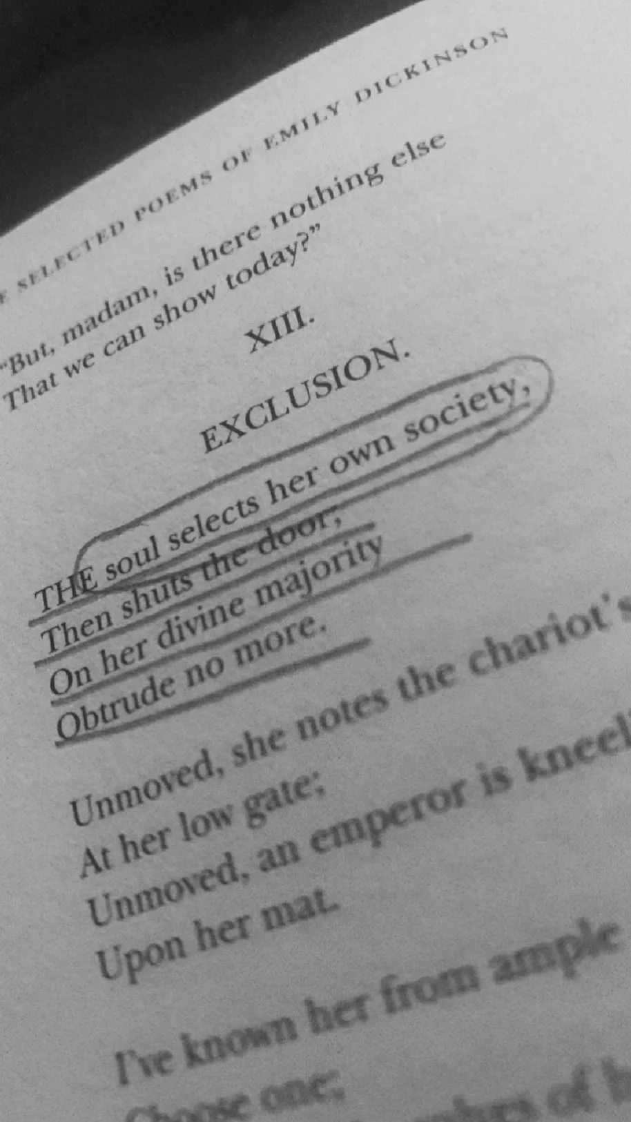 Close-up of a page from a book showing a poem, with the subtitle 'EXCLUSION.' The poem discusses a soul selecting her society and shutting the door on the divine majority.