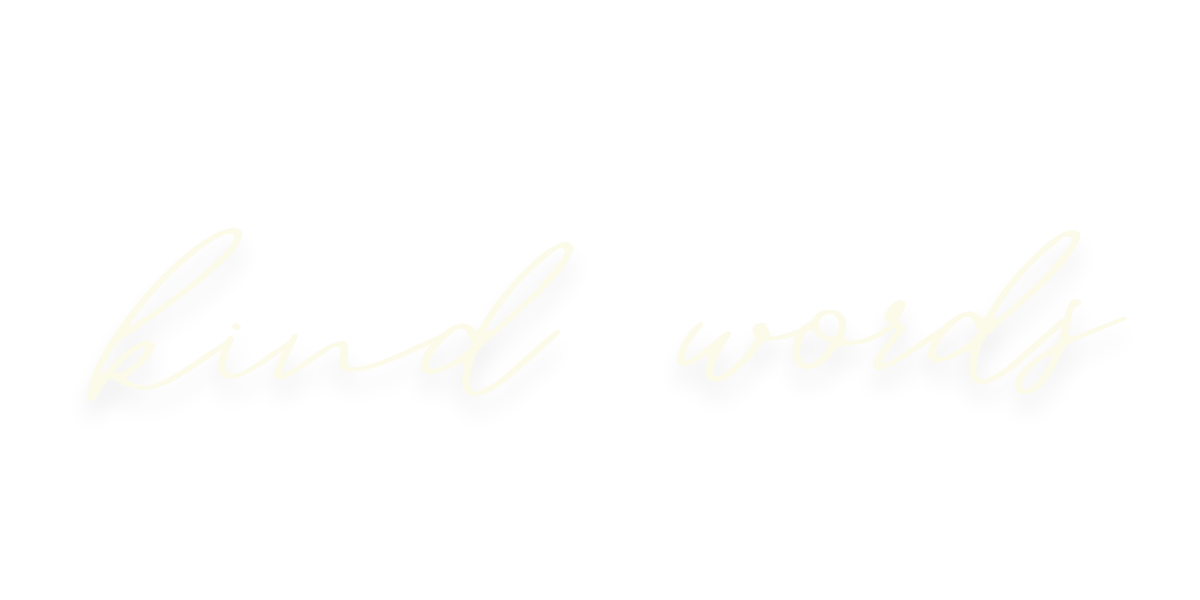 The phrase 'kind words' written in elegant, cursive script on a black background.