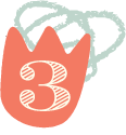 A pink mug with the number 3 on it and a cat face design on the front.