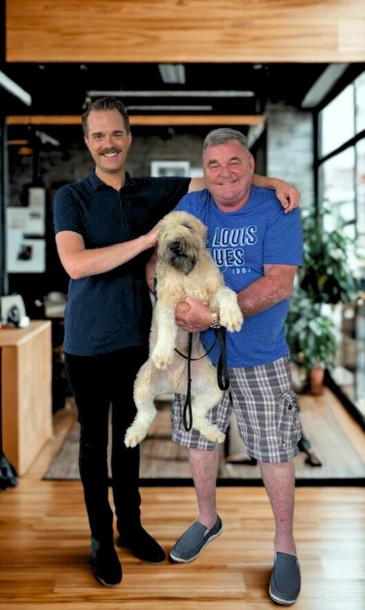 Rueben Wuerdeman, a top Eureka MO real estate agent, standing next to his client a man who is holding a dog smiling because he just closed on his new home in Eureka MO 