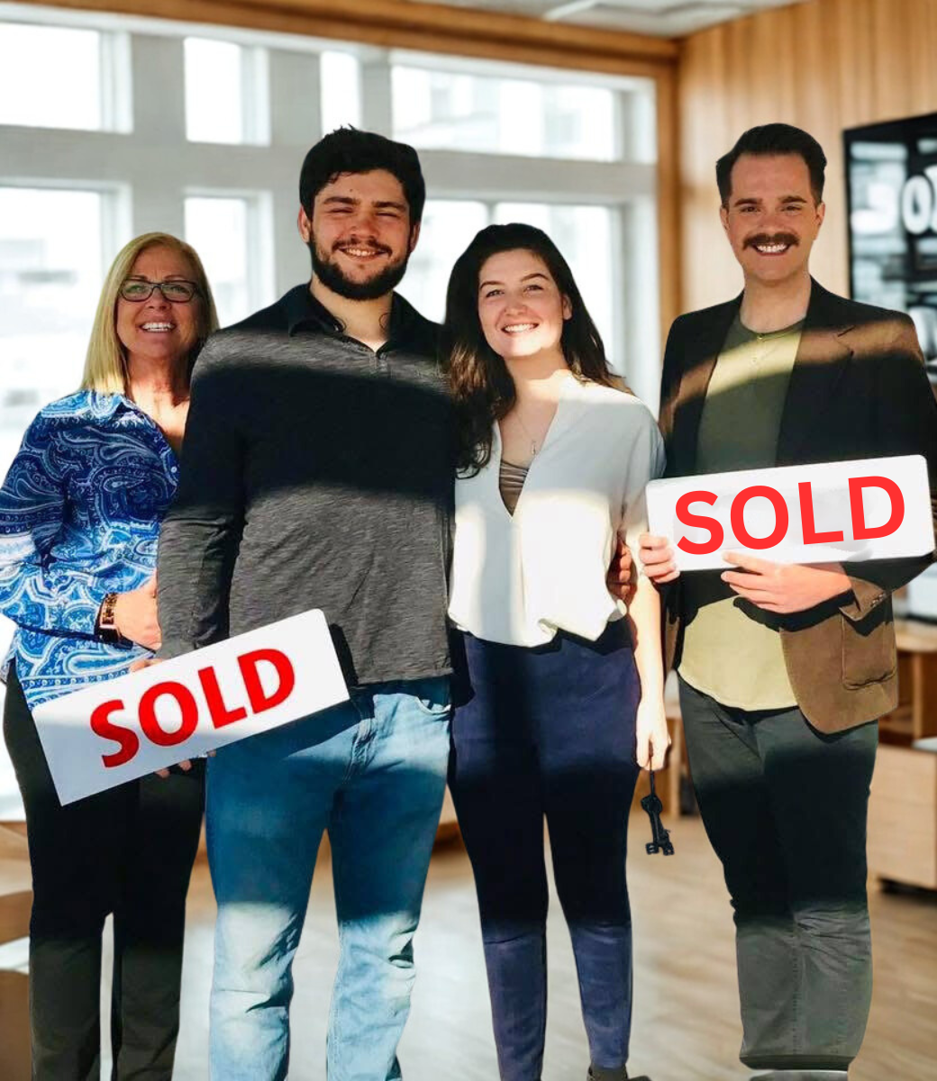 Rueben Wuerdeman, a top Eureka MO real estate agent, standing next to his clients a man and woman and their mother smiling holding a sold sign they just closed on their new home in Eureka MO 