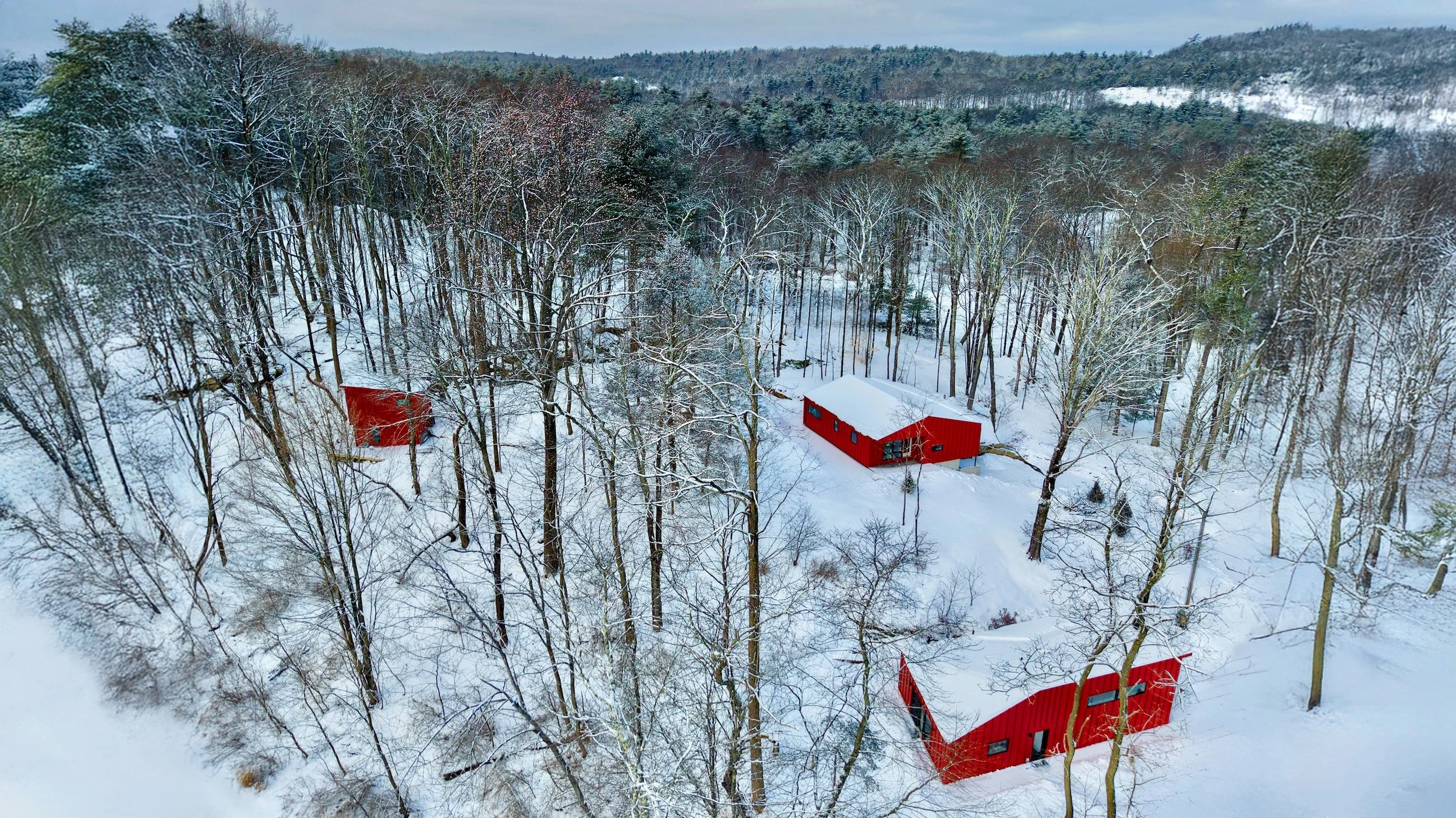 Skink Hollow exterior image of 3 red building surrounded by snow.