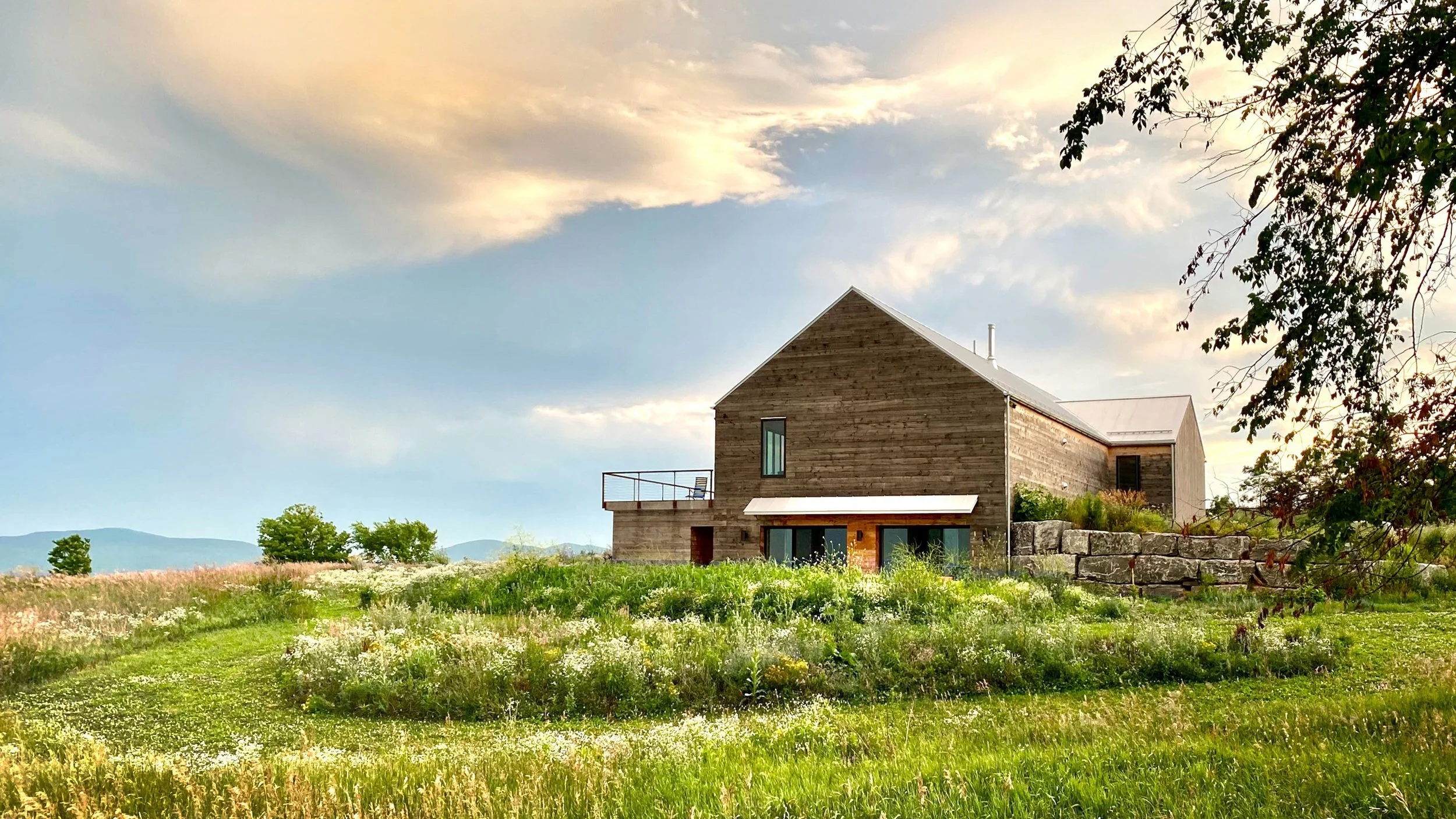 Exterior of Medusa single-family residence, with large meadow.