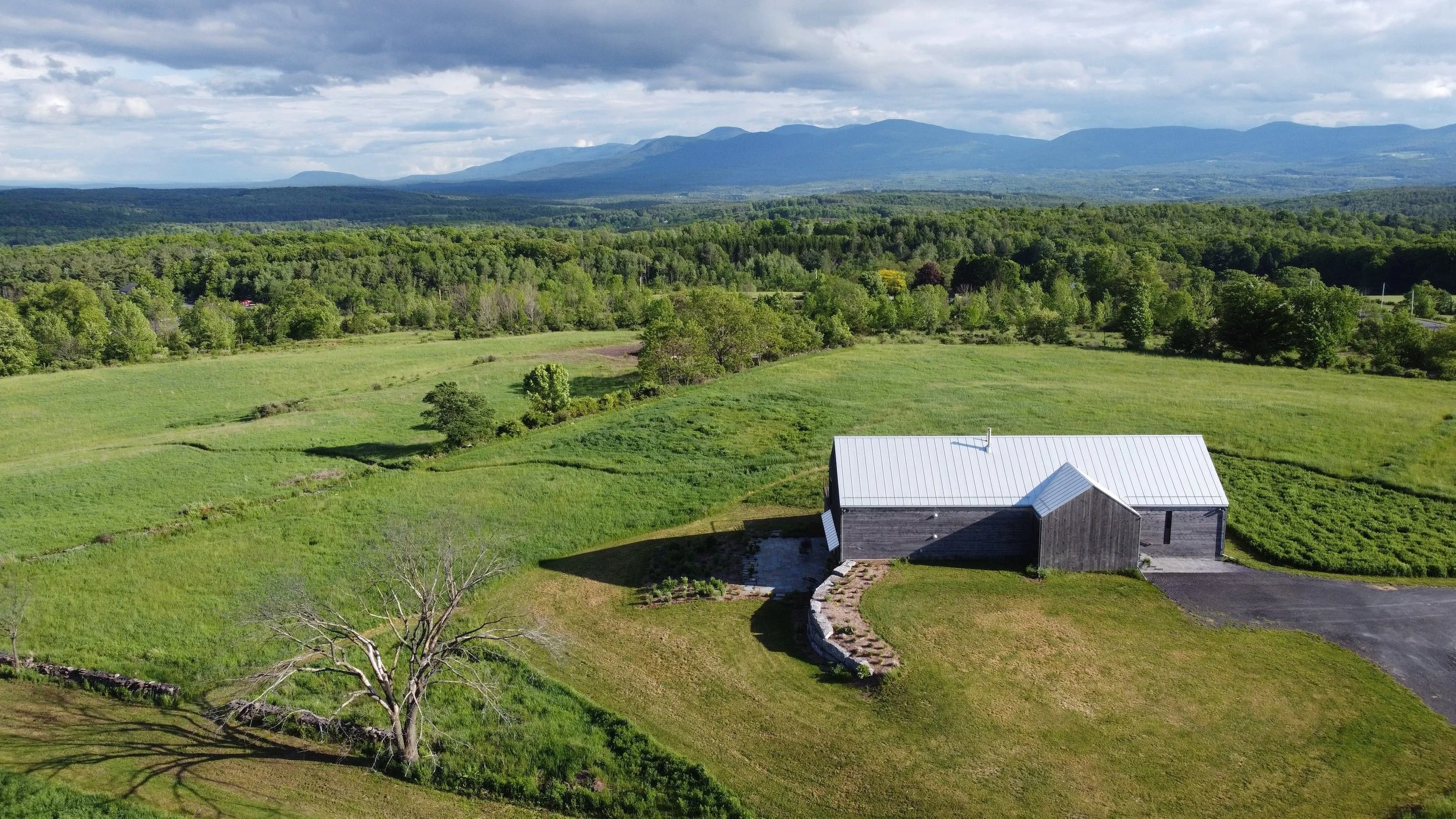 erial view of Medusa residence in Medusa NY, featuring modern barn architecture and locally milled wood finishes.