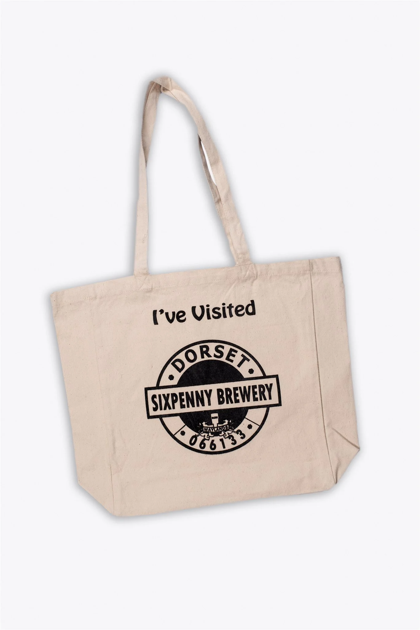 A beige tote bag with the text "I've Visited" above a circular logo for Sixpenny Brewery, located in Dorset, with black text and design elements.