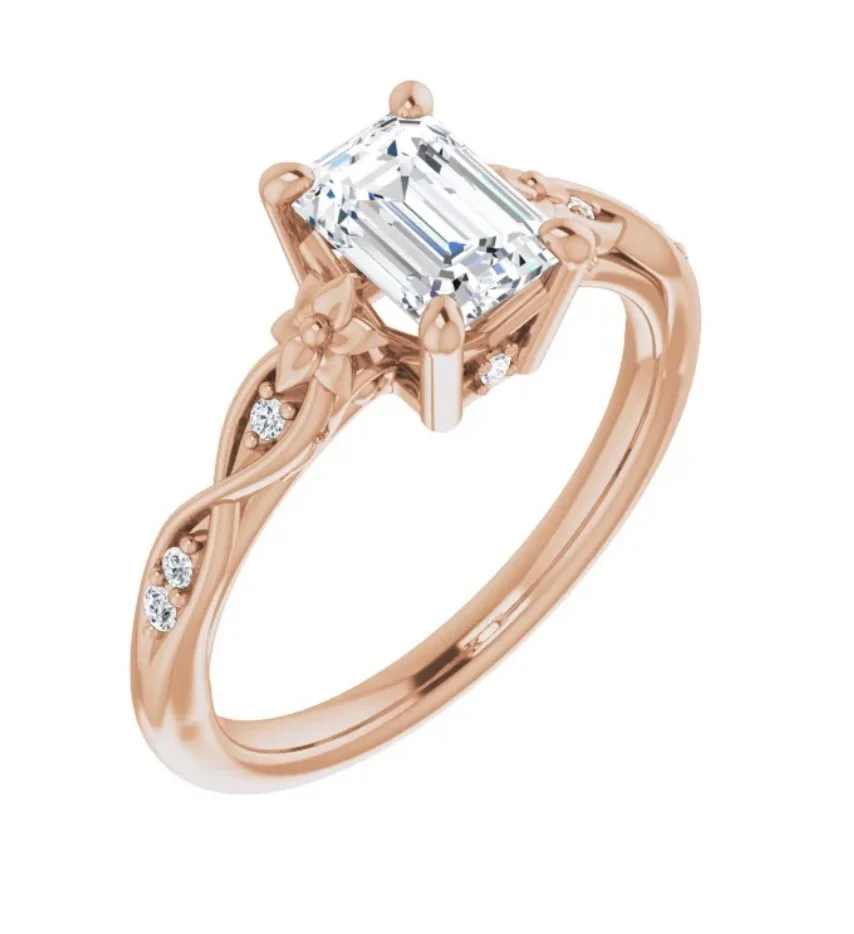 A rose gold ring with a large rectangular clear gemstone and small diamonds embedded in the band.